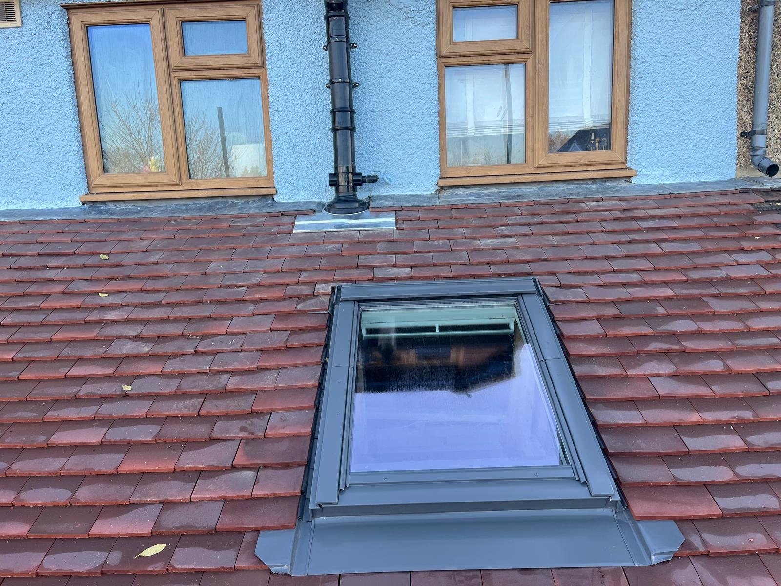 Renovated roof with new Velux windows and fully re-tiled surface for improved durability and light.