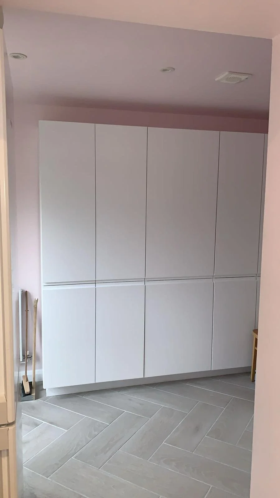 Custom full-length kitchen-diner cupboard fitted to maximise storage space and complement the room design.