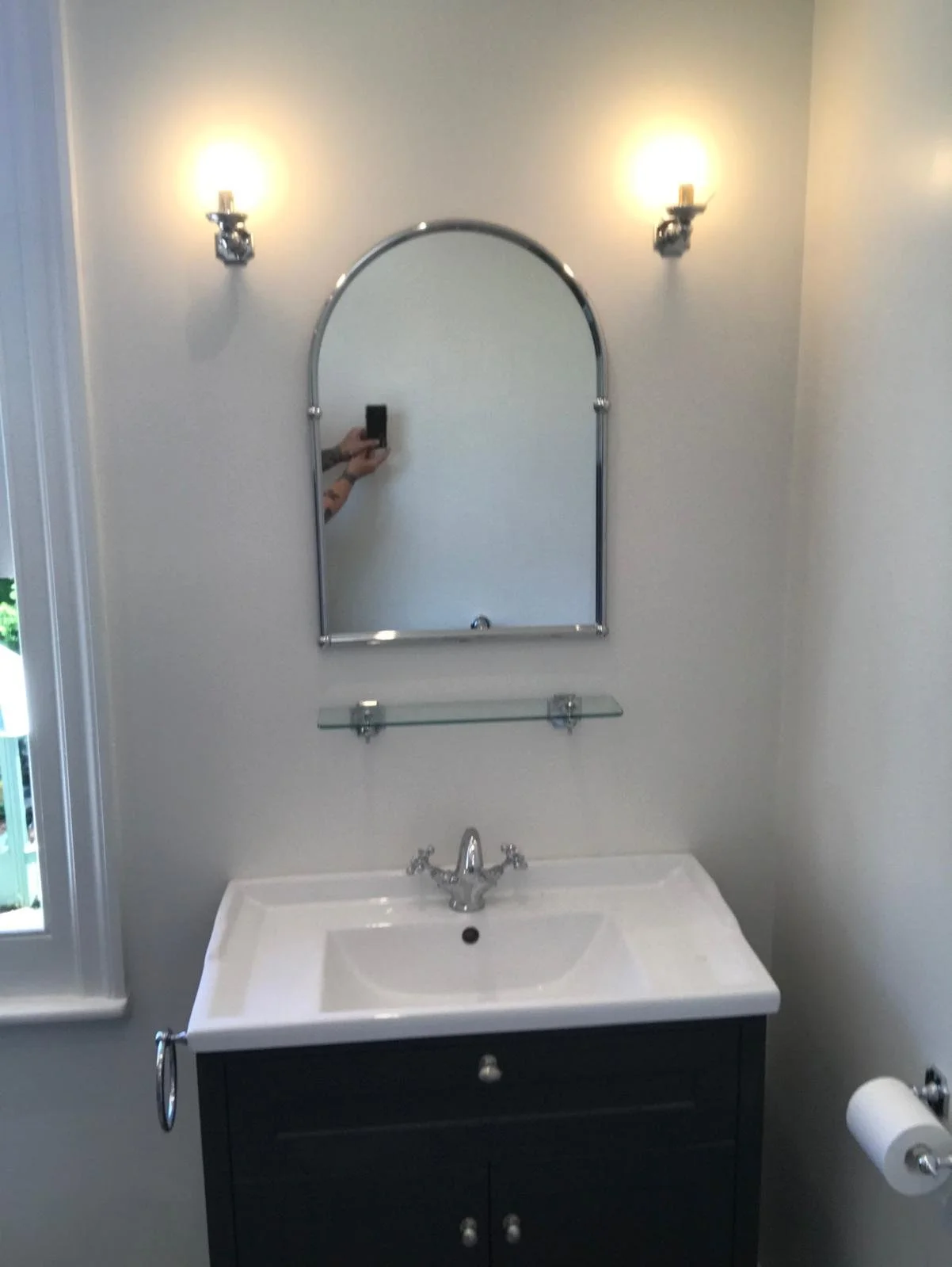 Bathroom renovation featuring a vanity unit and upgraded lighting designed to enhance warmth and ambiance.