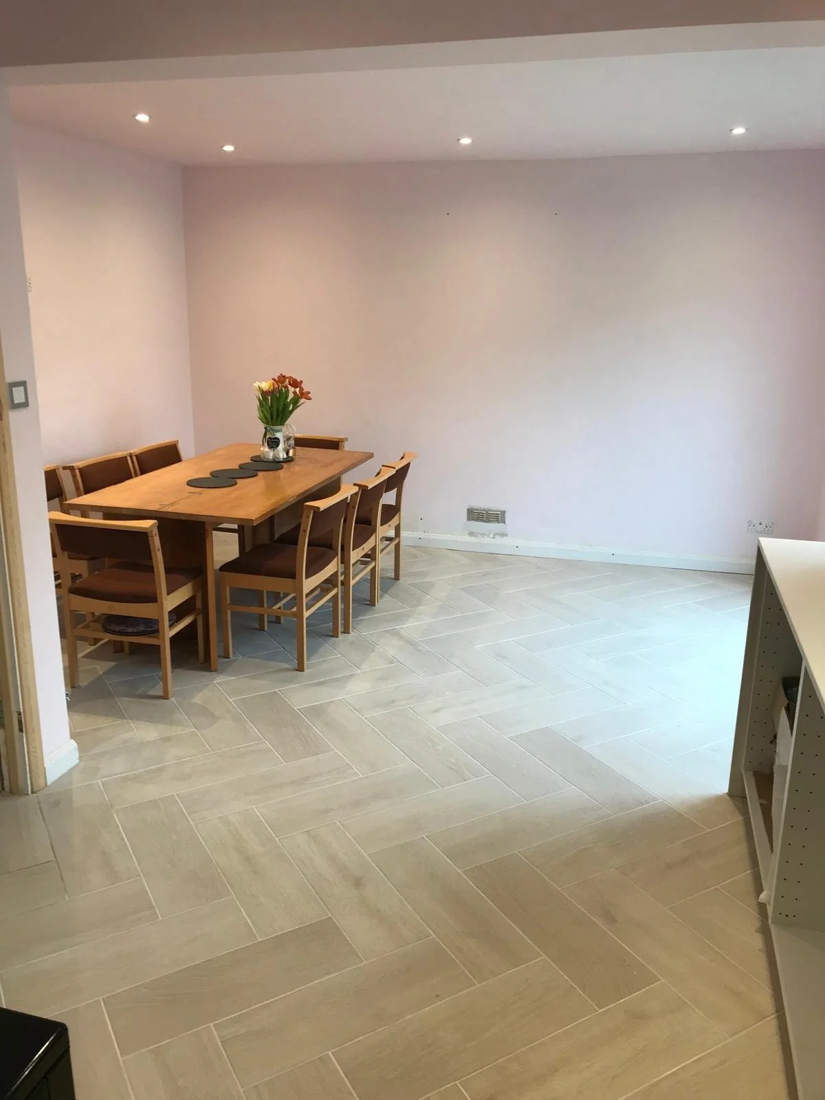 Structural renovation including wall removal, new RSJ installation, plastering, spotlights, and herringbon flooring throughout. Lintel fitted to address cracking caused by insufficient support.