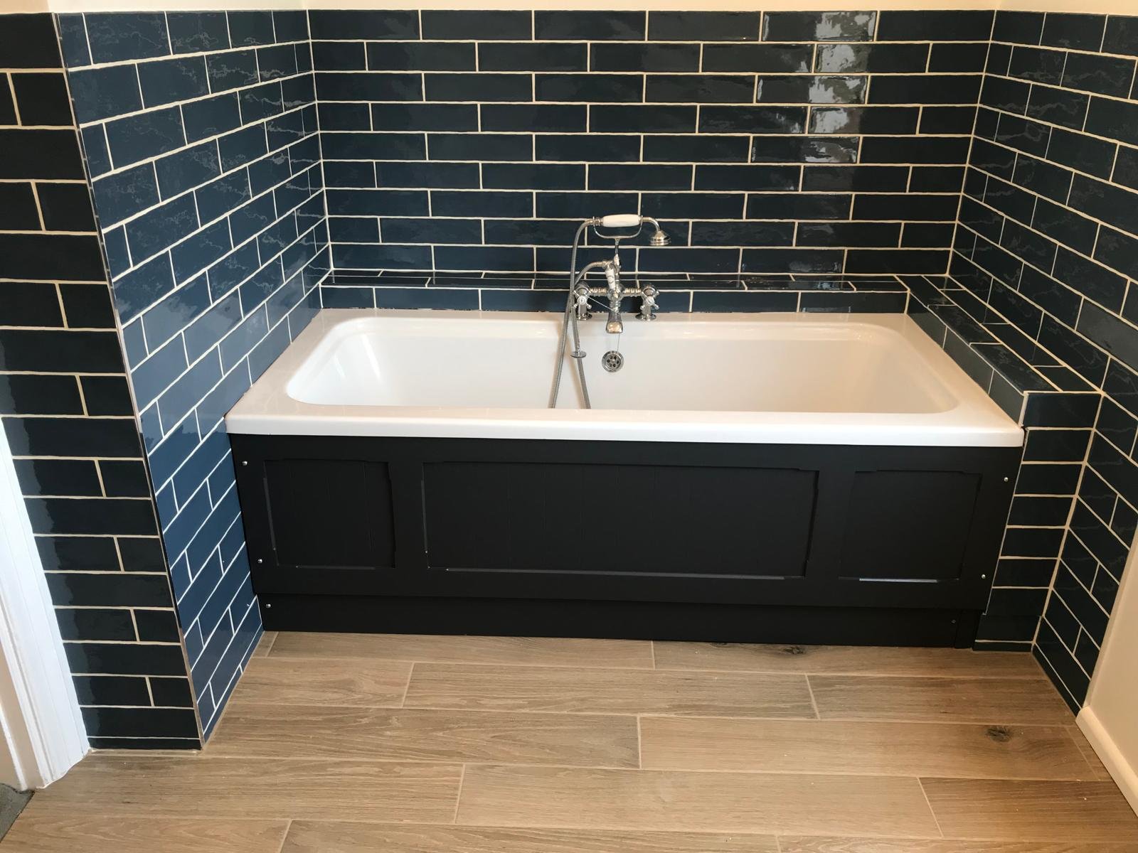 Bathroom renovation with a built-in alcove bathtub, Victorian features, and period-style tiling.