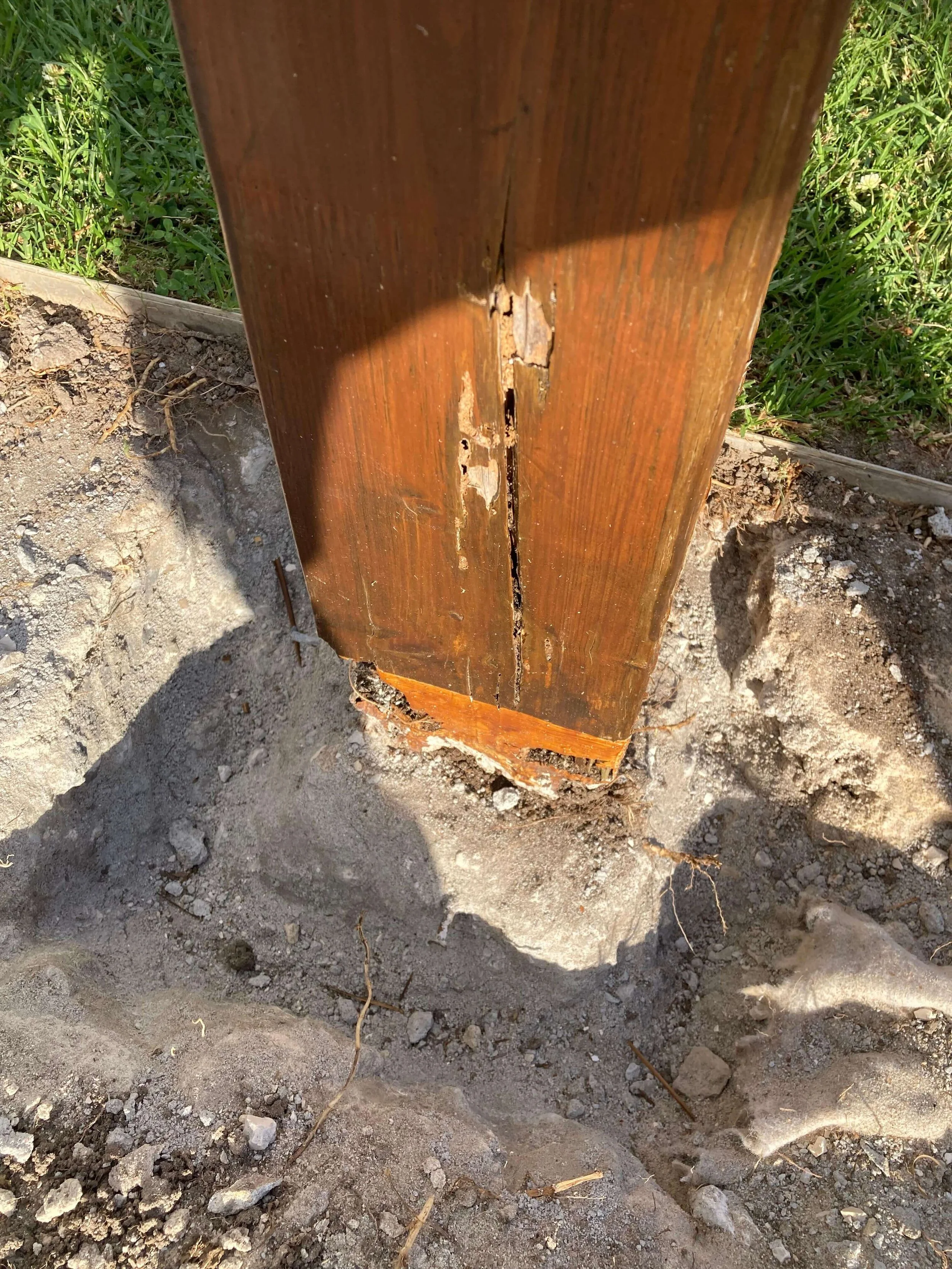 Close-up of a wooden post with peeling paint before renovation