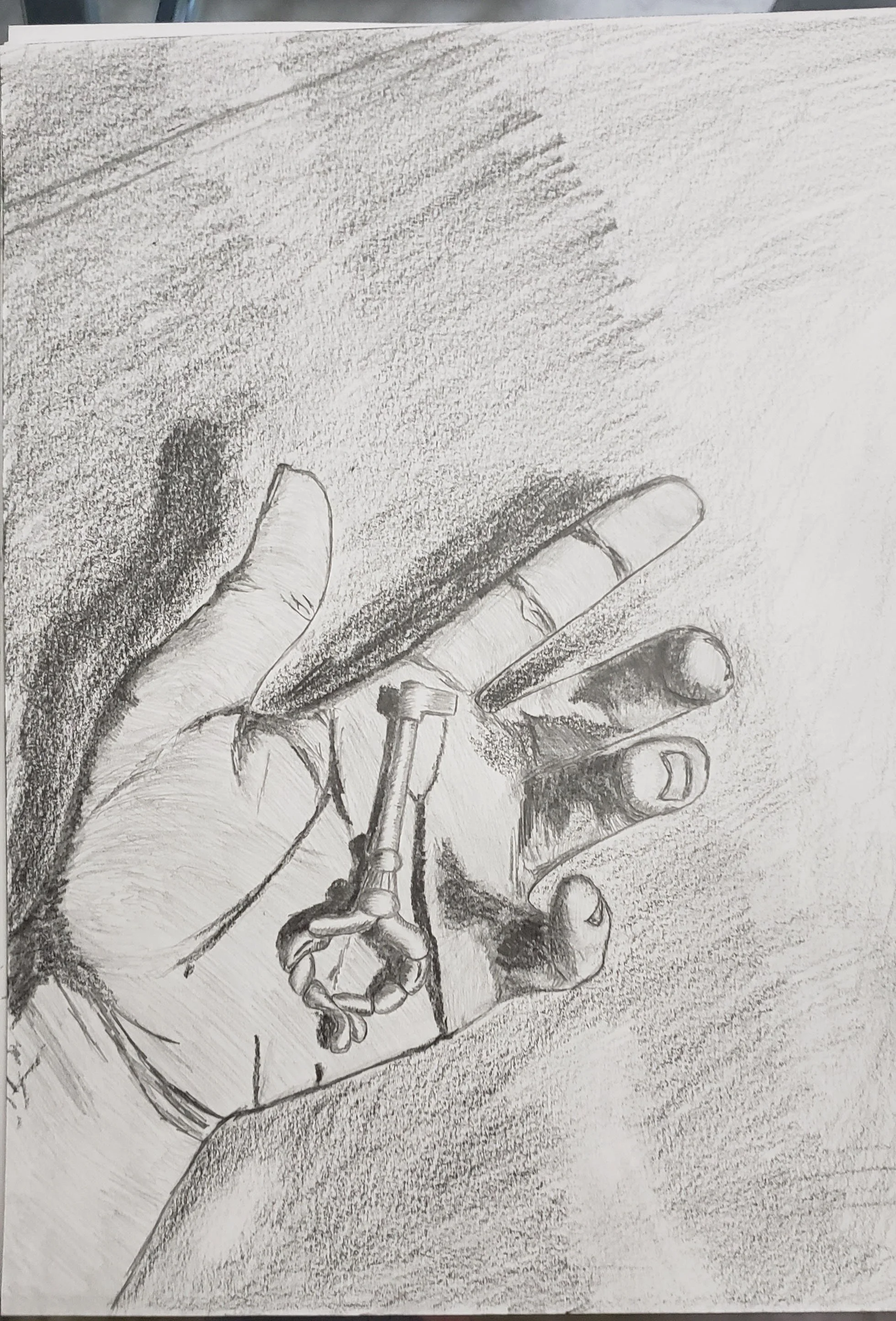 A pencil drawing of a hand holding a key.