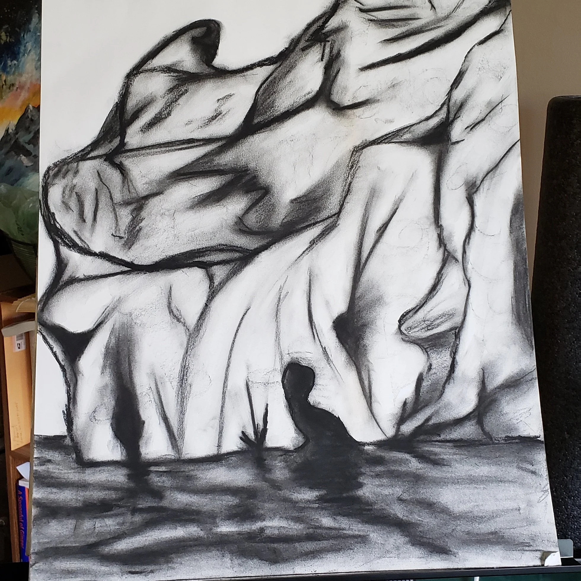 A black and white charcoal drawing of the water surface, with large abstract shapes and formations in the background.