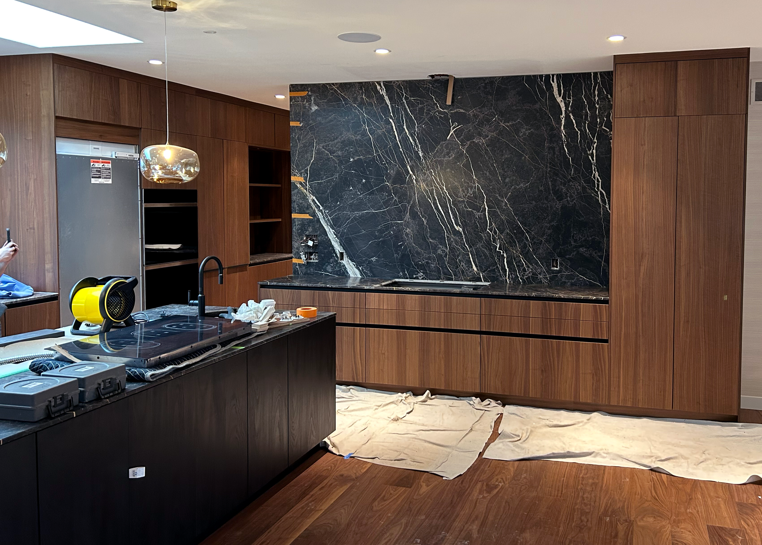 Stonecrafters custom black marble backsplash and kitchen island installation in a modern home