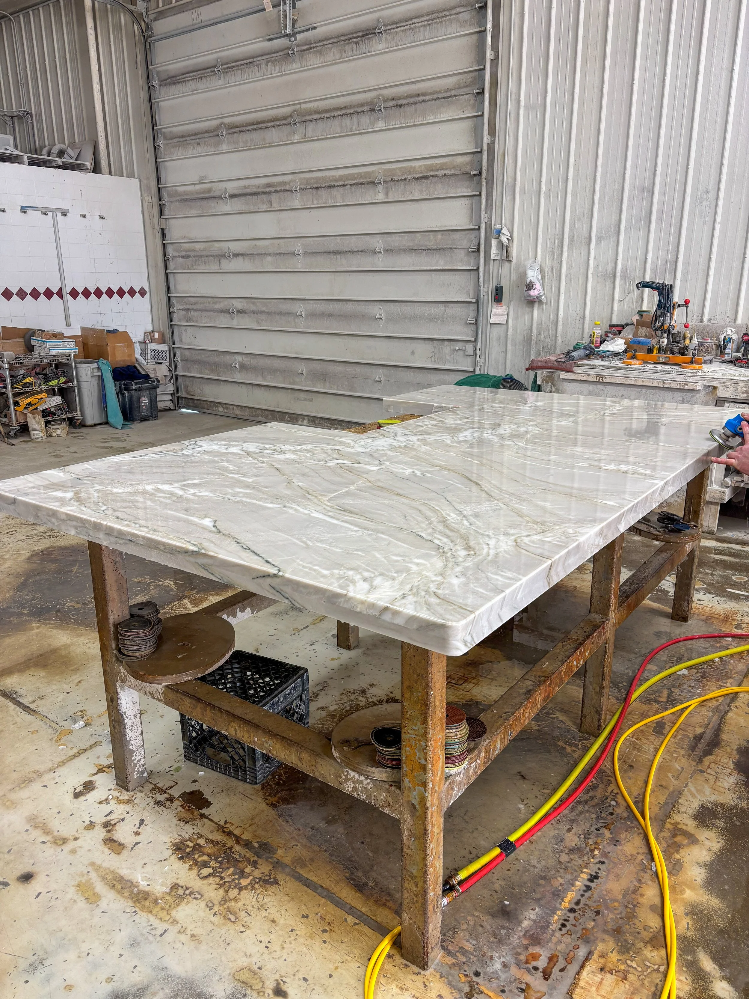 Inside Stonecrafters' stone fabrication workshop – marble slab being prepared for custom residential countertop installation