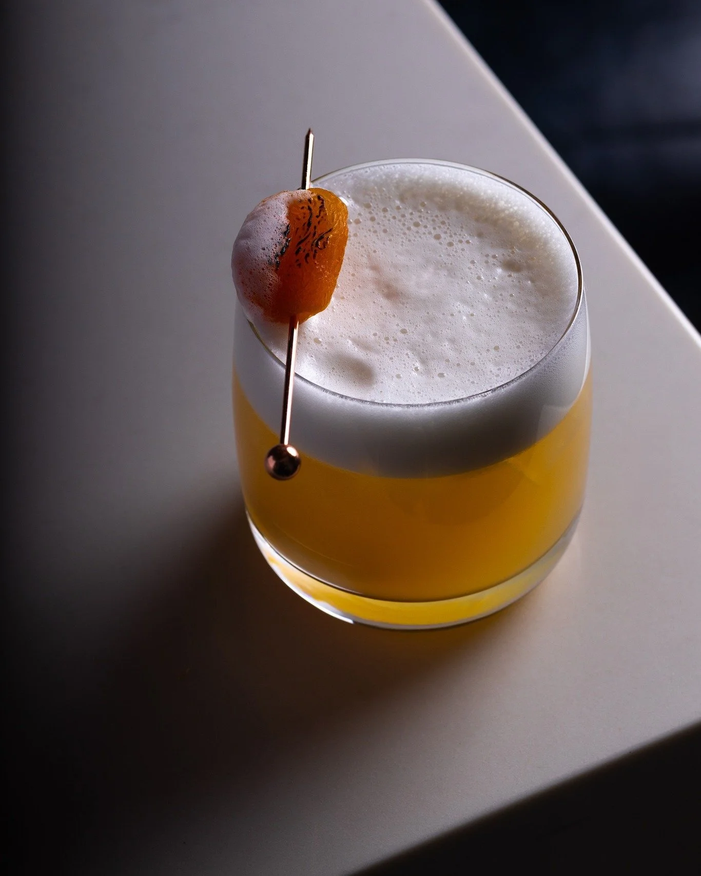 The Apricot Sour is one of those drinks that makes sense the moment you try it. Stone fruit sweetness from the apricot brandy, lemon cutting right through it, and a frothy top from the vegan foamer. Classic sour formula, just done well. 

{house whis