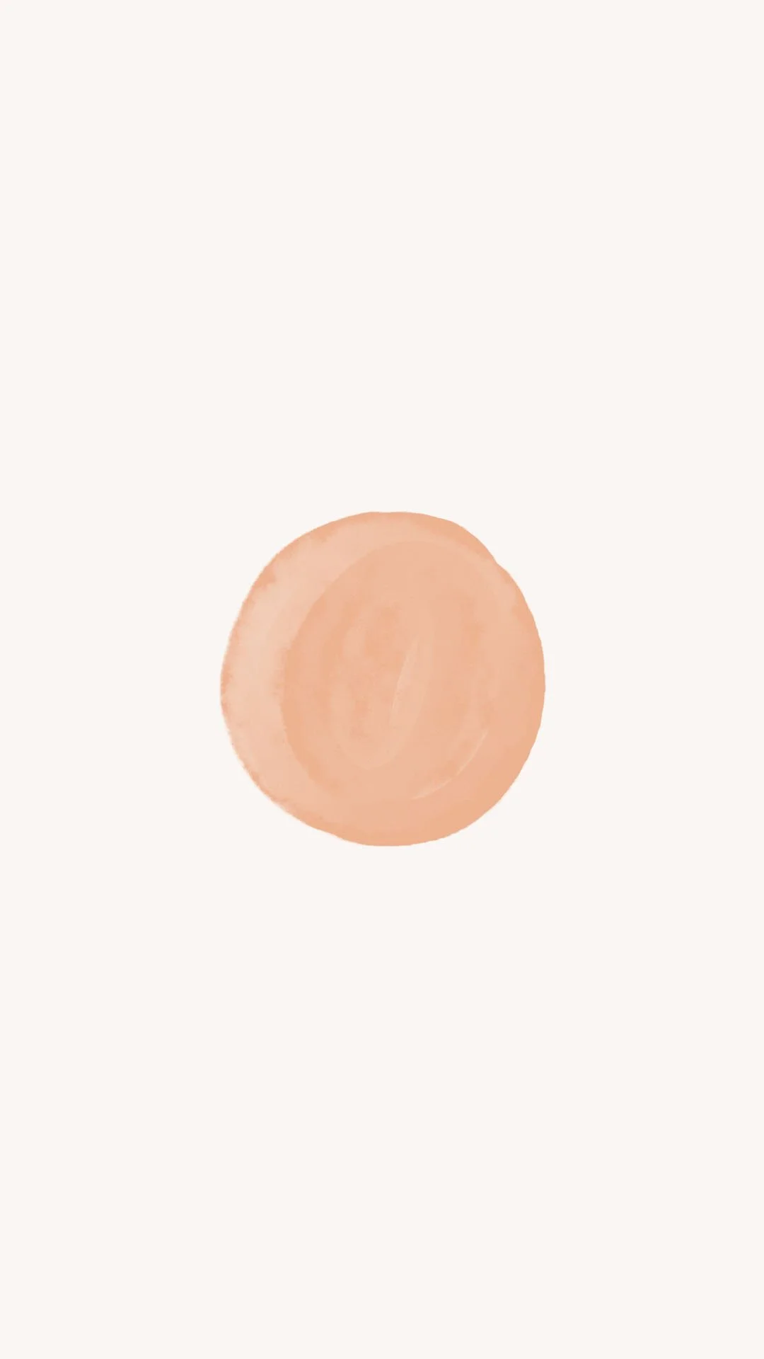 Close-up of a peach-colored circular object on a white background.