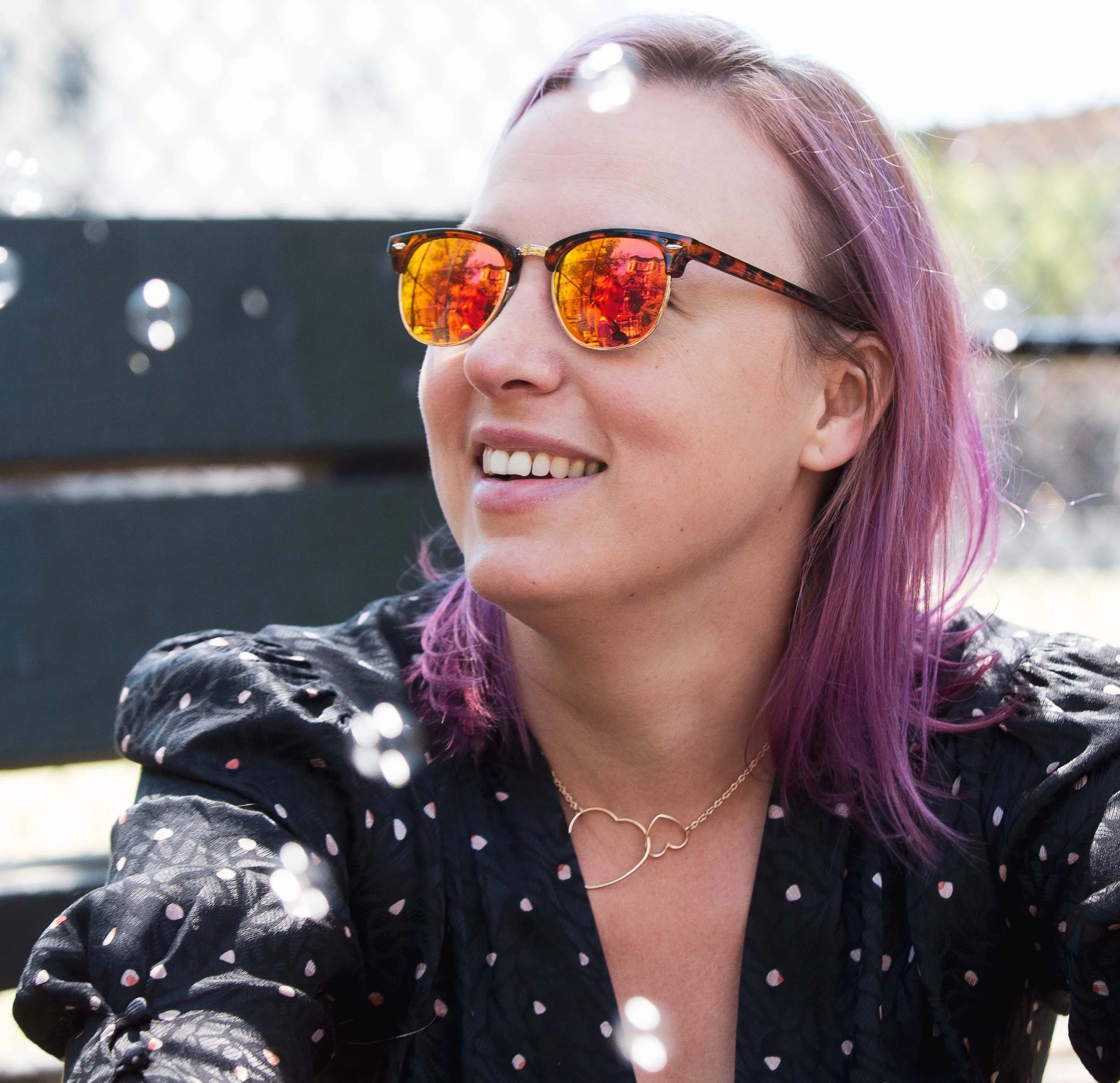 Gwen Schroeder headshot - white woman with purple hair