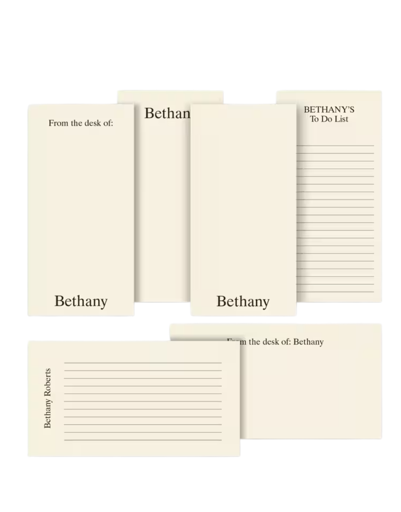 Collection of personalized  desk accessories including a notepad, a to-do list pad, and several notepads.