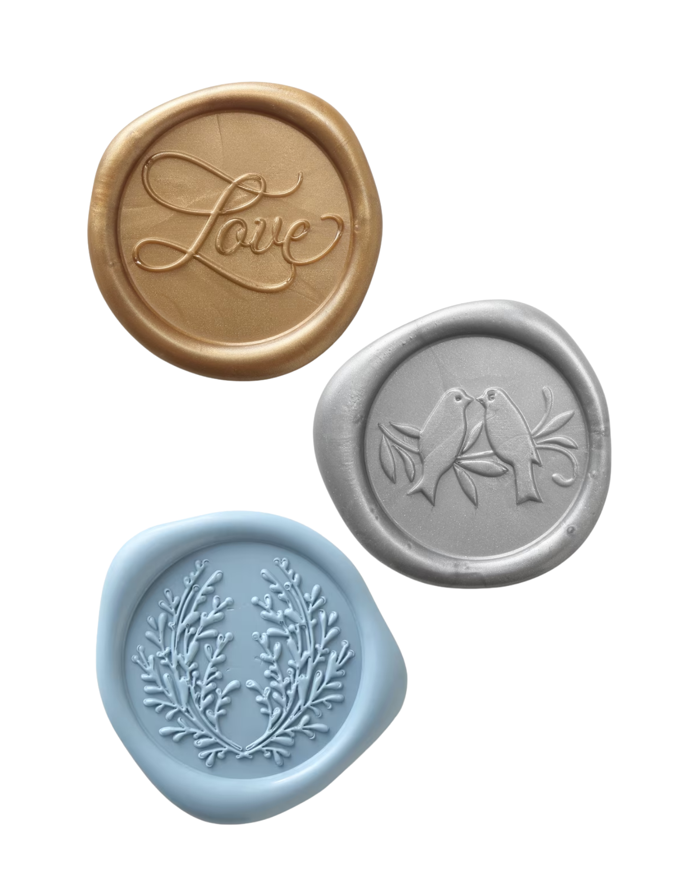 Three wax seals in brown, silver, and light blue colors with embossed designs: 'Love' in cursive, two birds on a branch, and laurel branches respectively.