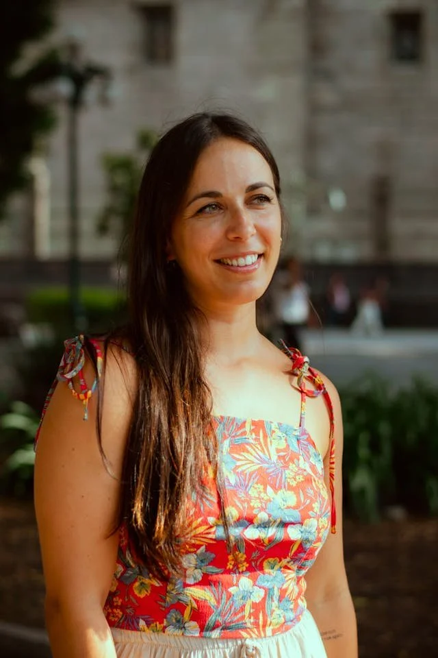 A woman in a floral dress smiling