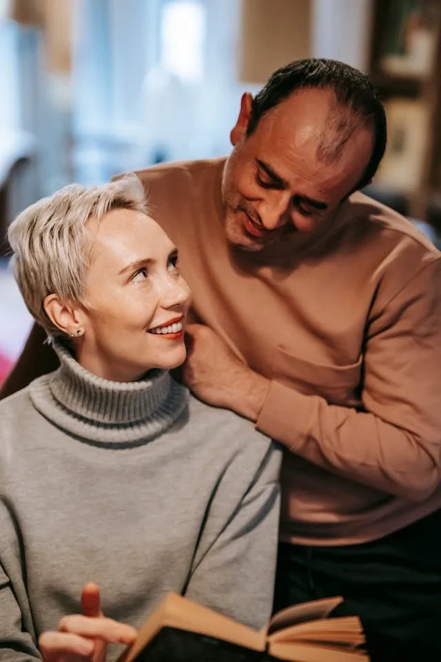 A man and a woman smiling at each other