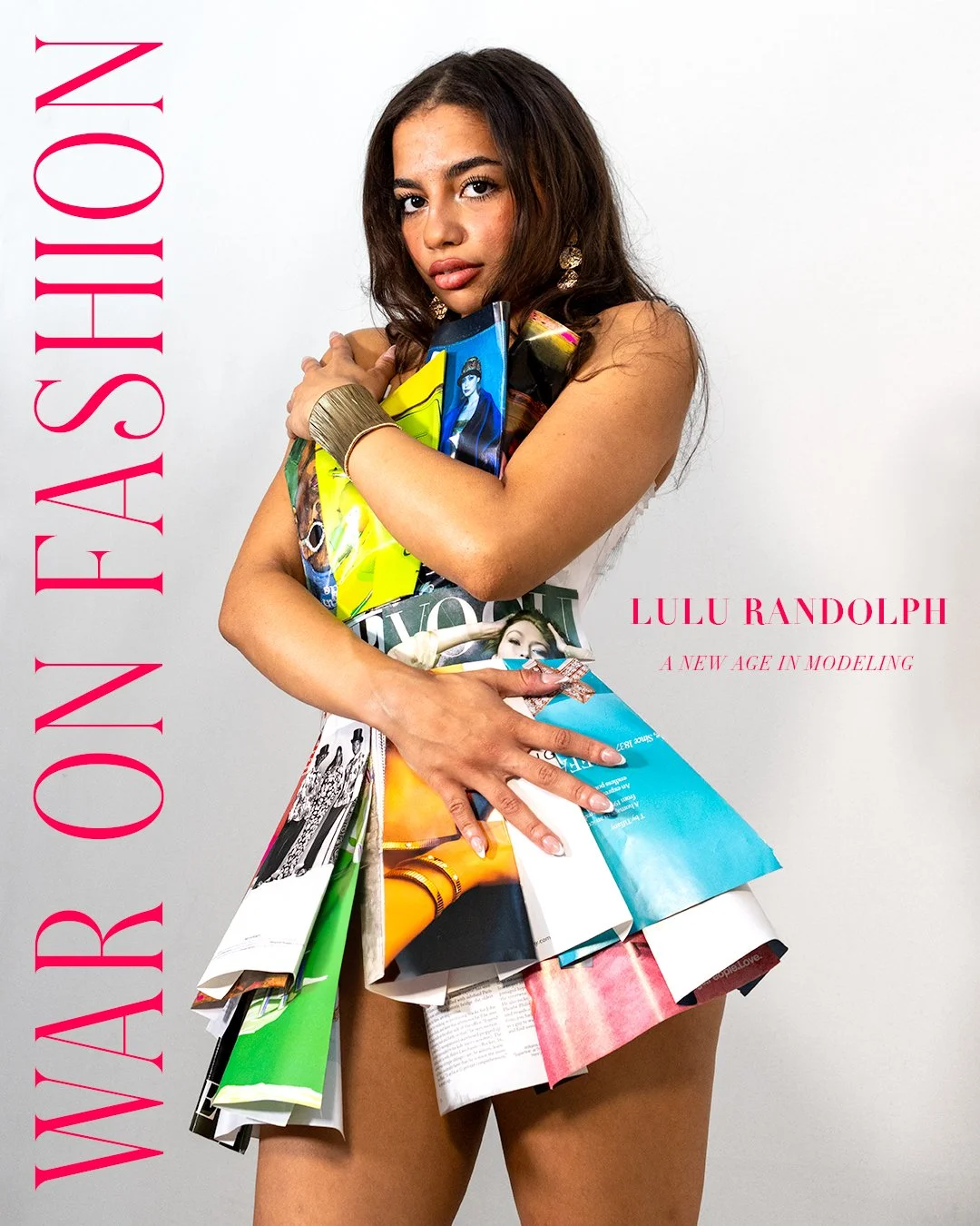 Young woman with long dark hair posing against a gray background, holding magazines and wearing minimal clothing. Text on the image includes "WAR ON FASHION" vertically on the left side, and "LULU RANDOLPH A NEW AGE IN MODELING" on the right side.