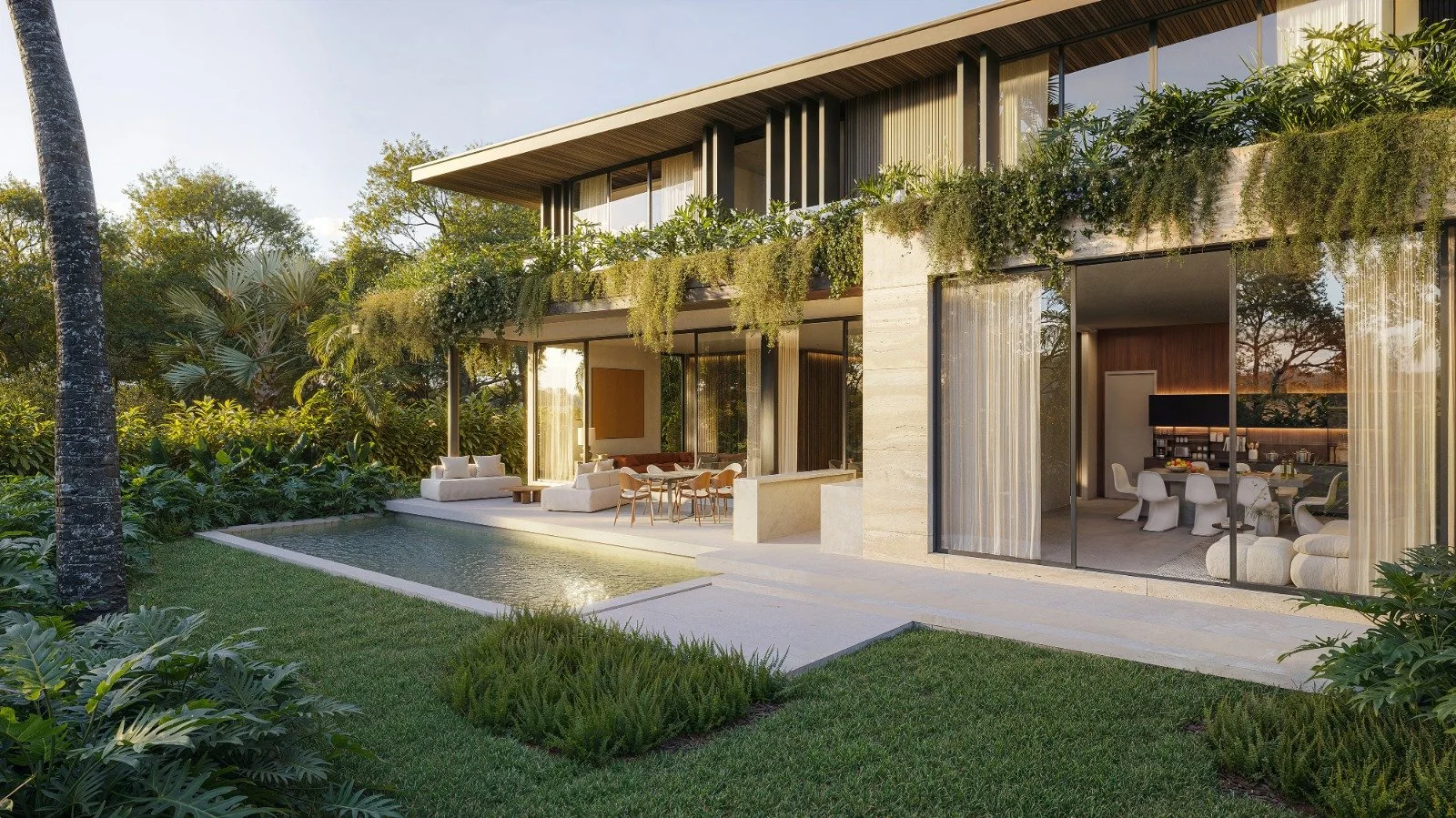 Modern house with large glass walls, outdoor seating area, swimming pool, lush green garden, and interior view of a dining area.