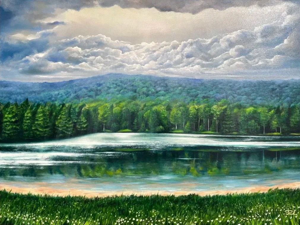 A serene landscape painting of a lake reflecting green trees and forested hills under a cloudy sky.