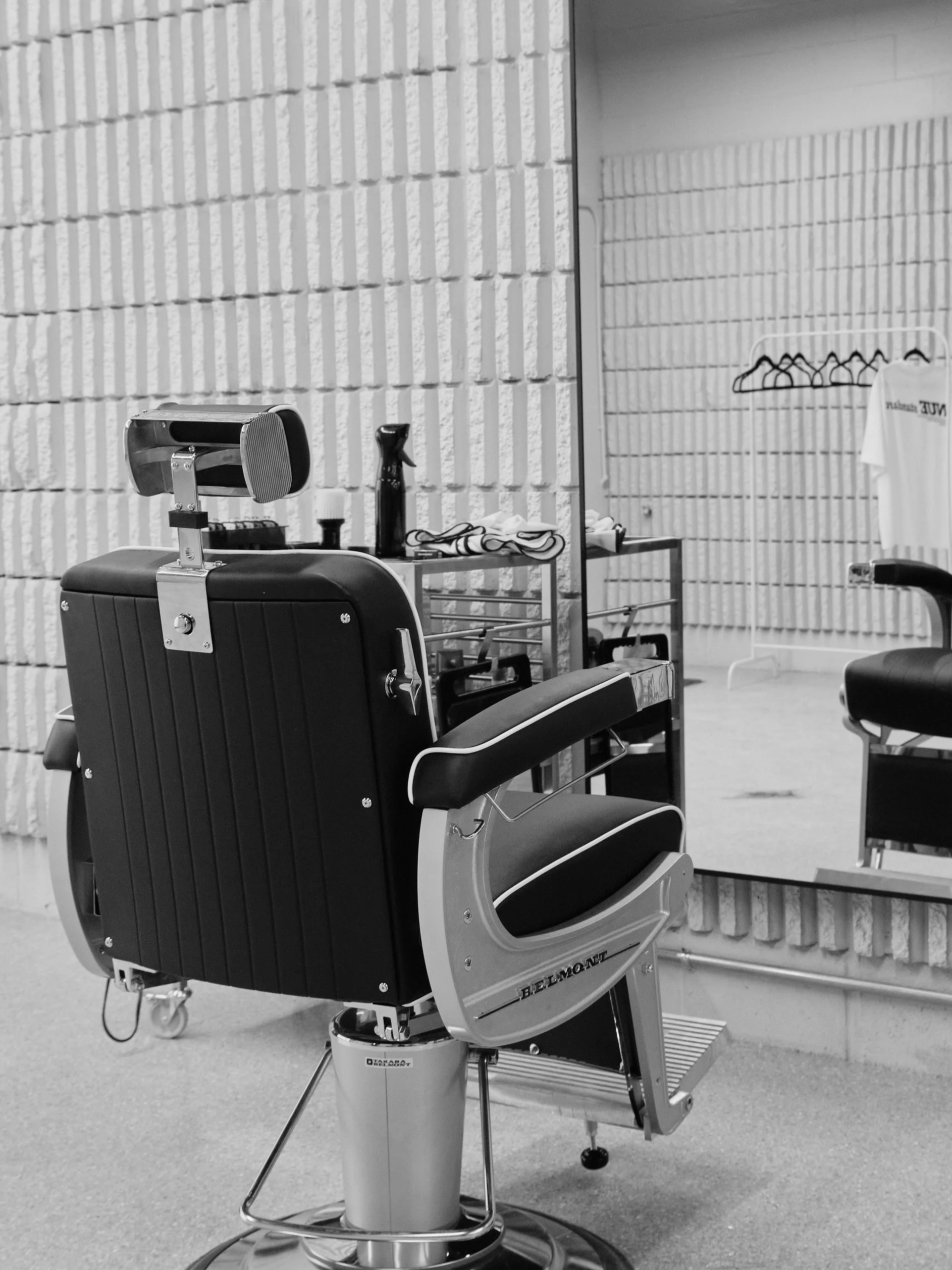 Empty barber chair facing mirror