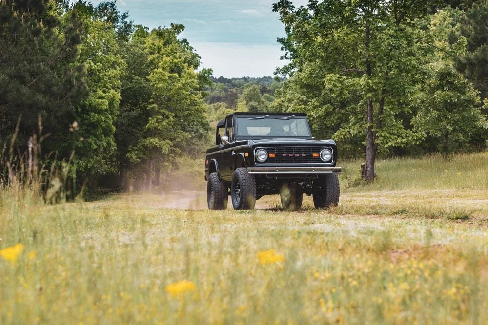Vintage-Bronco-in-all-black-driving-on-county-road-in-Tennessee.jpg