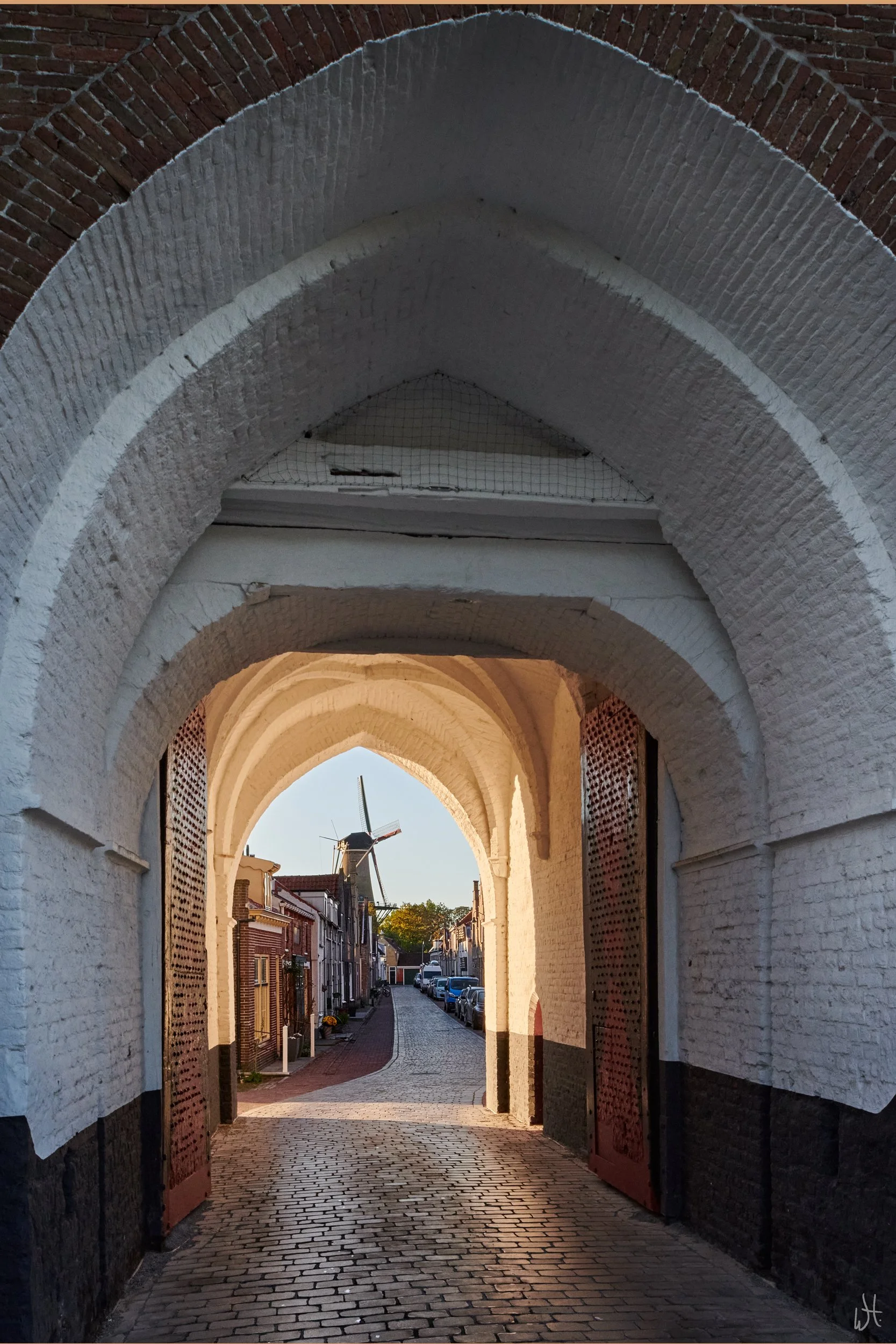 View through the 14th-century Nobelpoort in the Dutch town of Zierikzee, looking toward the windmill De Hoop, built in 1850.
