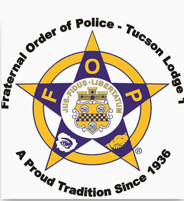 Emblem of the Fraternal Order of Police - Tucson Lodge 1 with a yellow star and purple shield, displaying a crest with a castle, 2 animals, and the motto 'FIDUS - LIBERTATUM'.