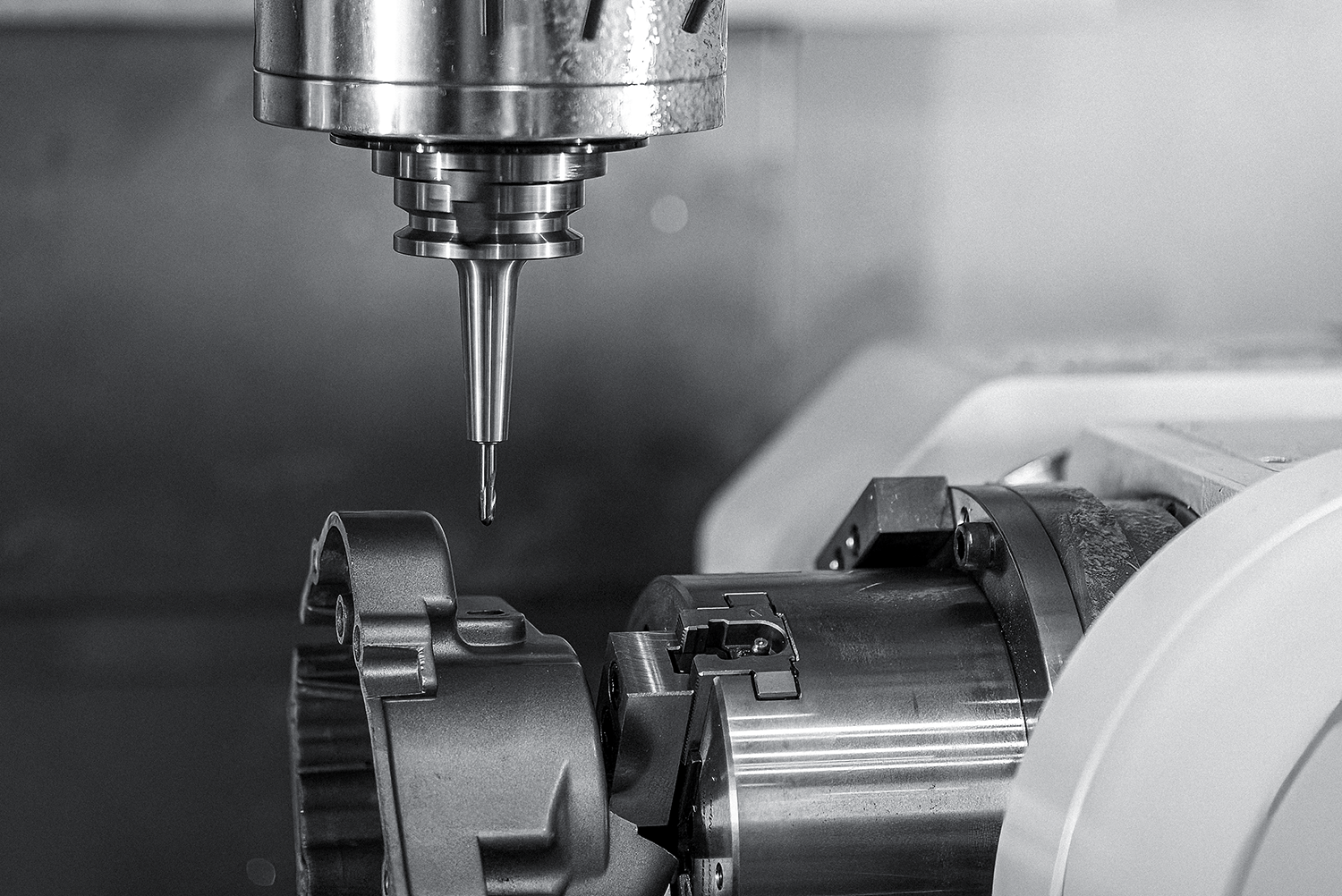 High-precision CNC spindle positioned over rheocast metal part.