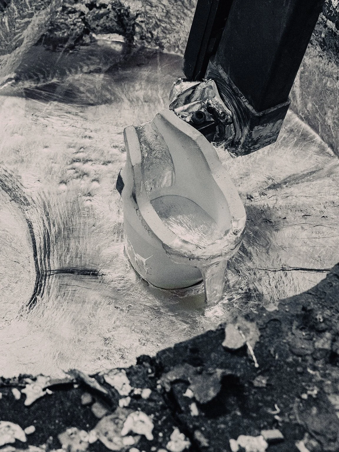 Semi-solid aluminum slurry surrounding ladle in Dynatool rheocasting process.