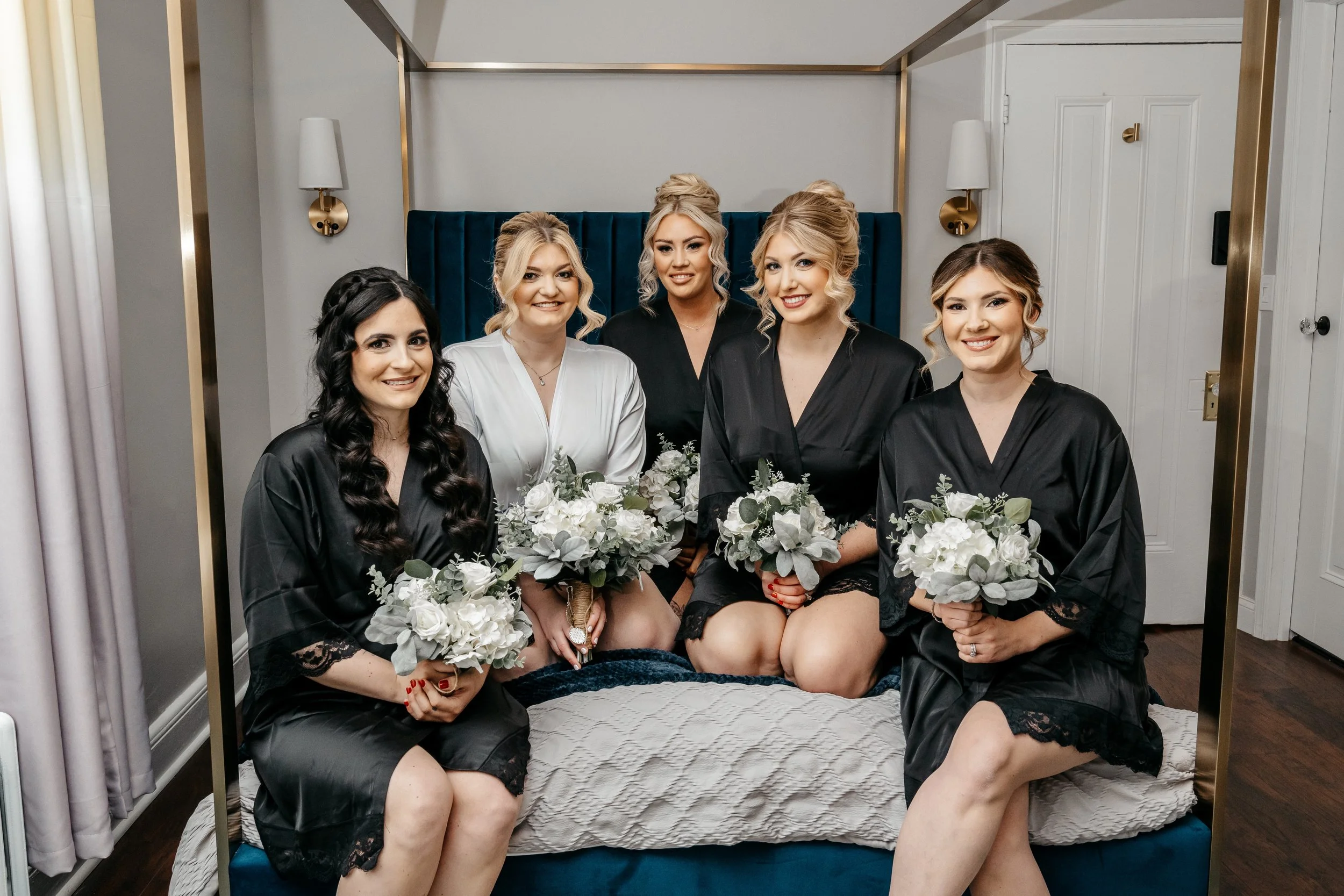 Bride and bridesmaids posing while getting ready