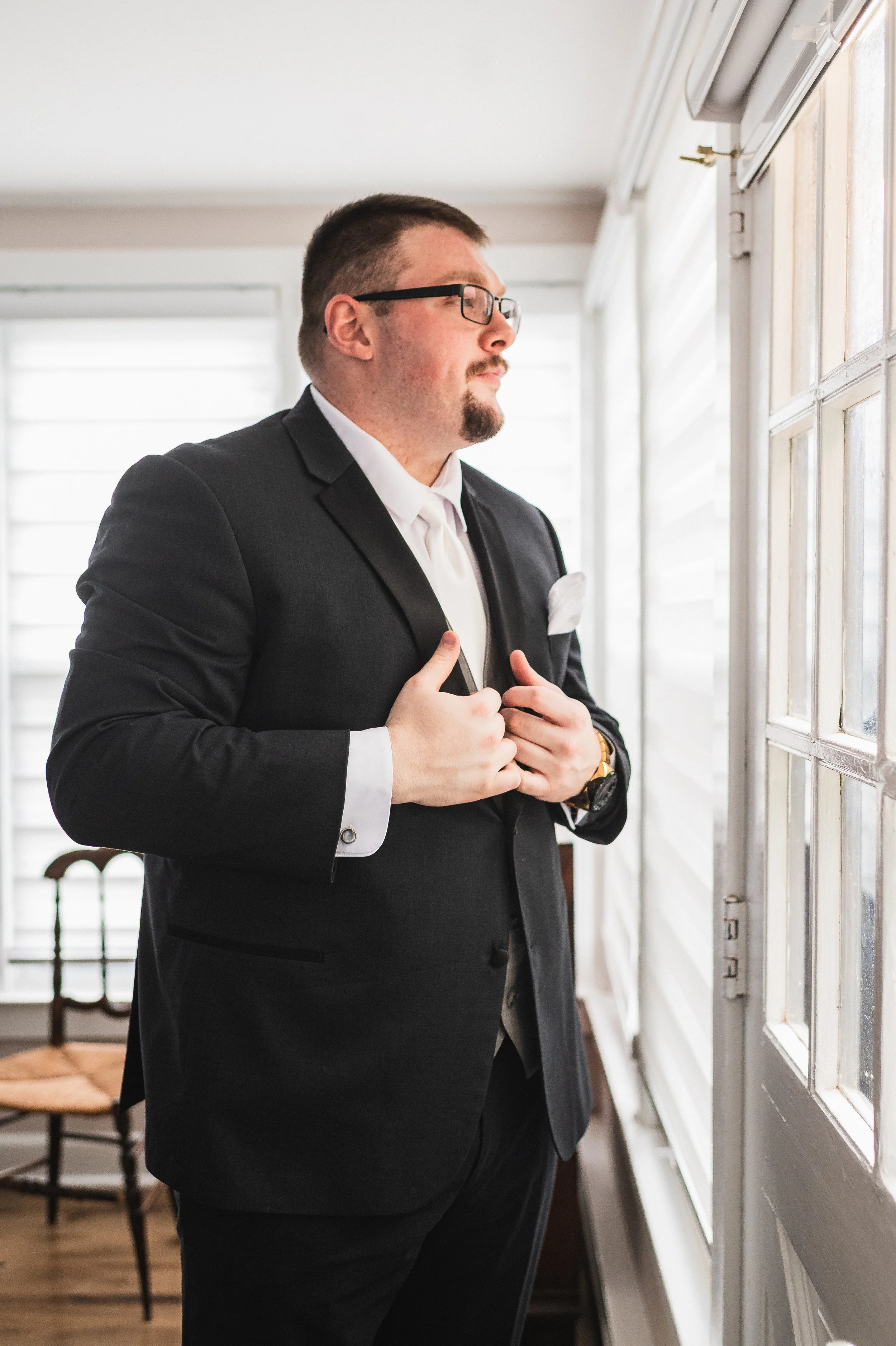 Groom looking out window