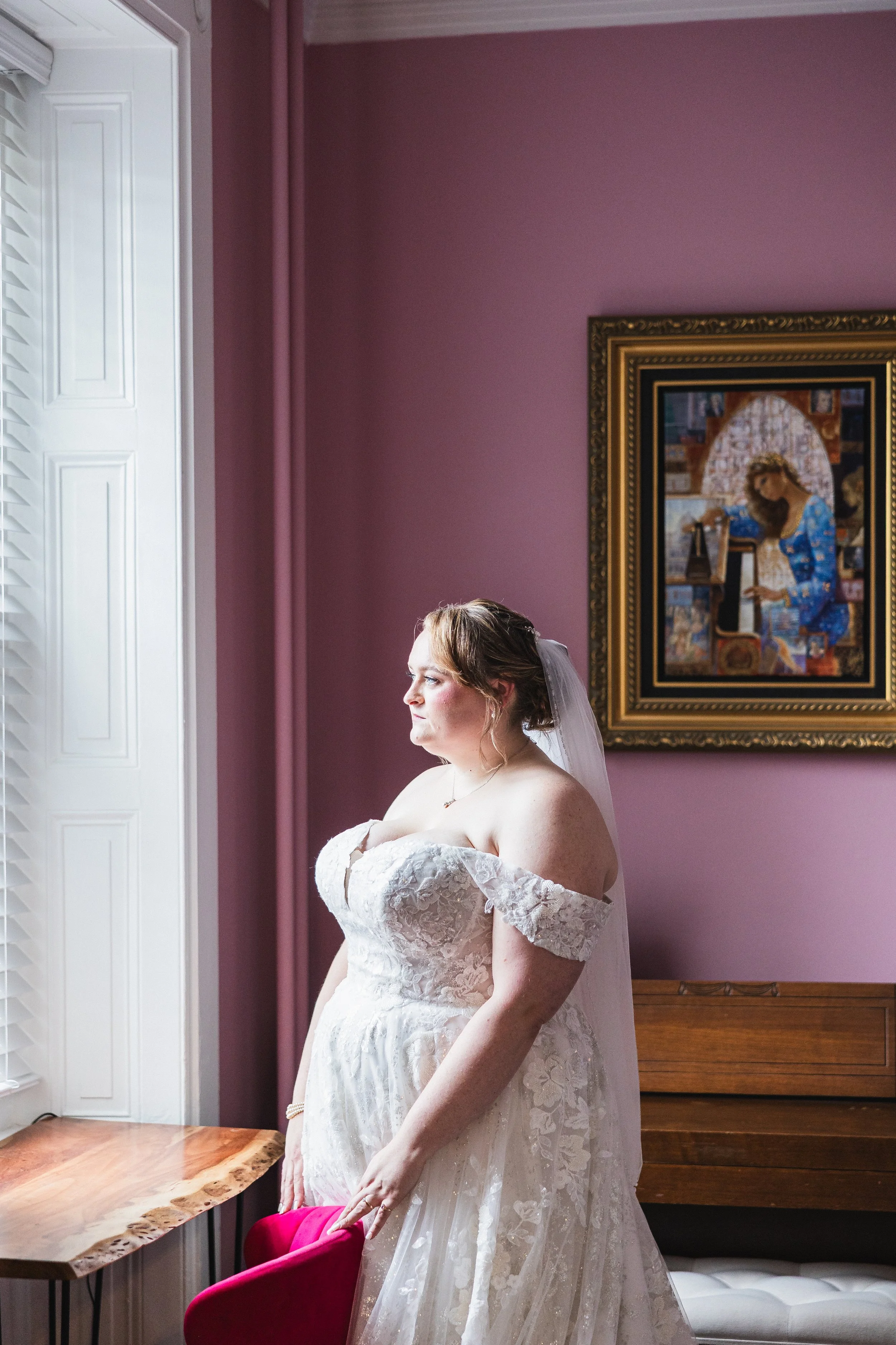 Bride looking out window