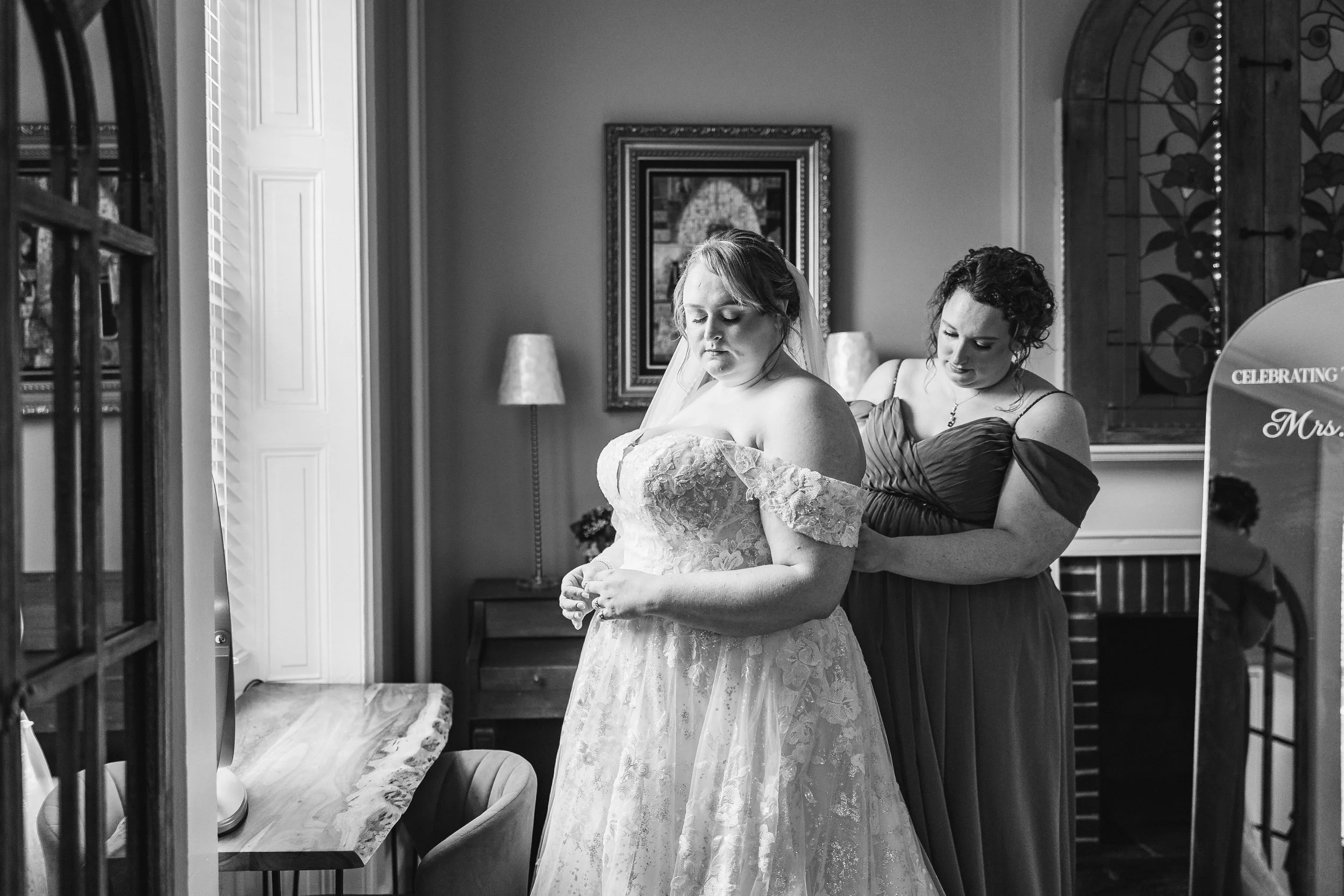 Bride in window getting ready