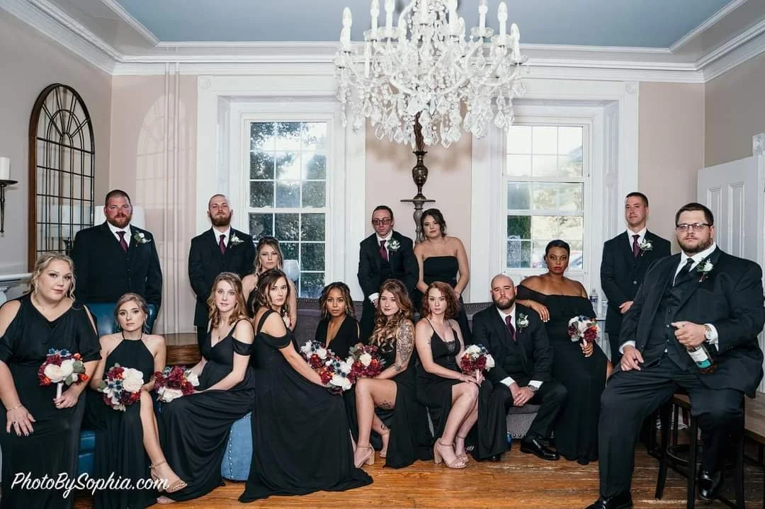 Bridal party posing for pictures in manor