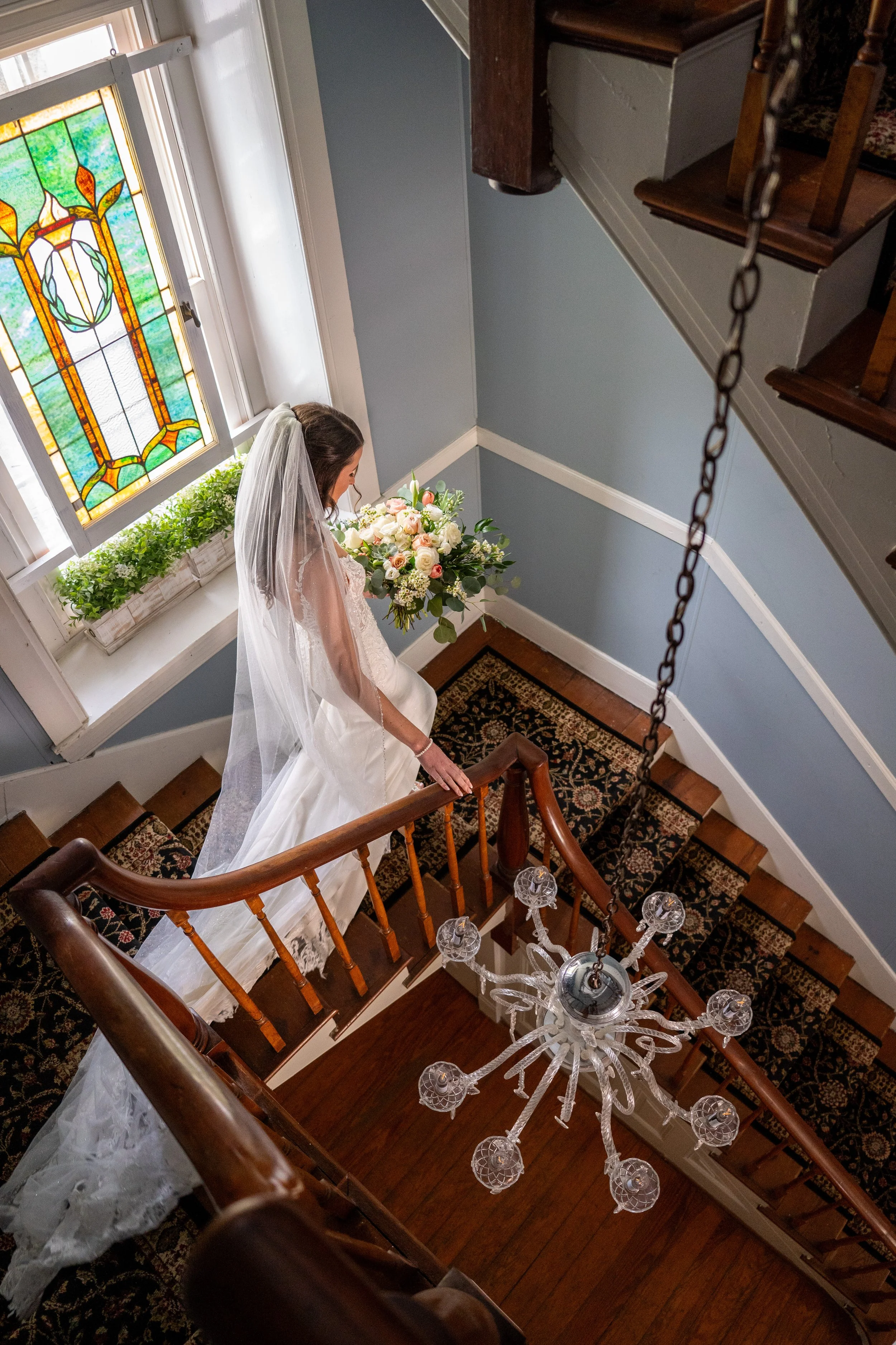 Bride coming down spiral stairs