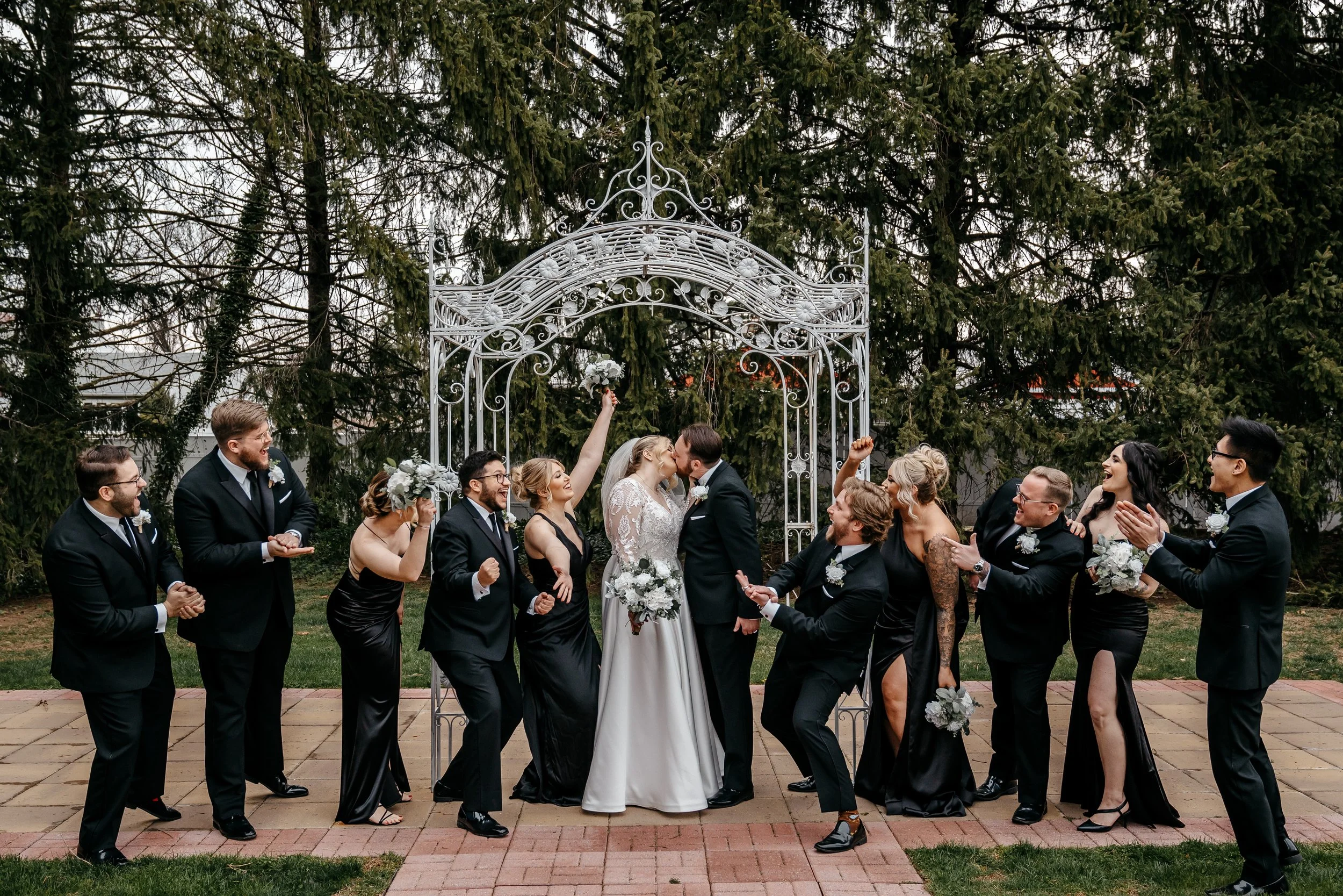 Bridal party under arch