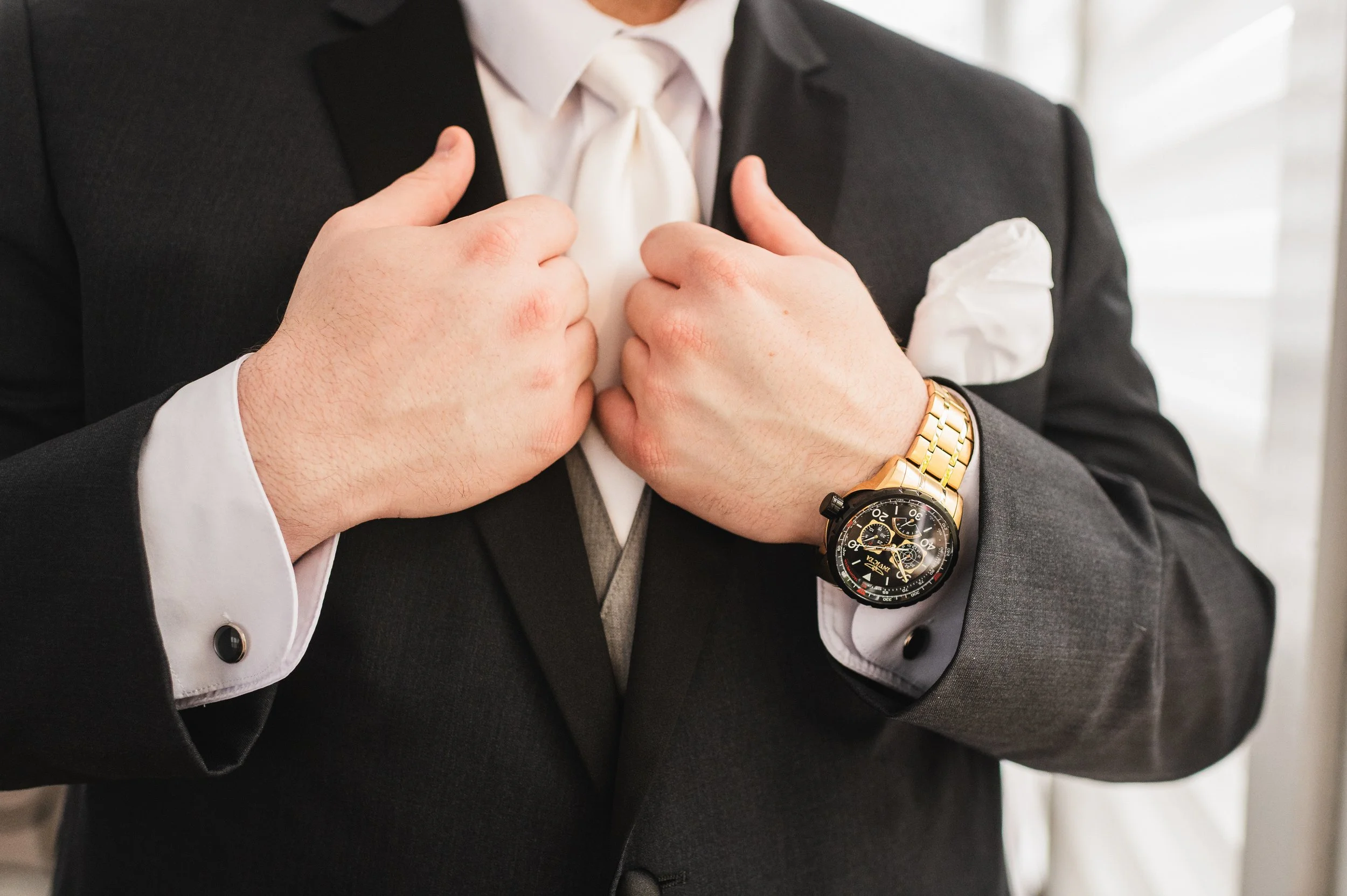Groom showing off suit