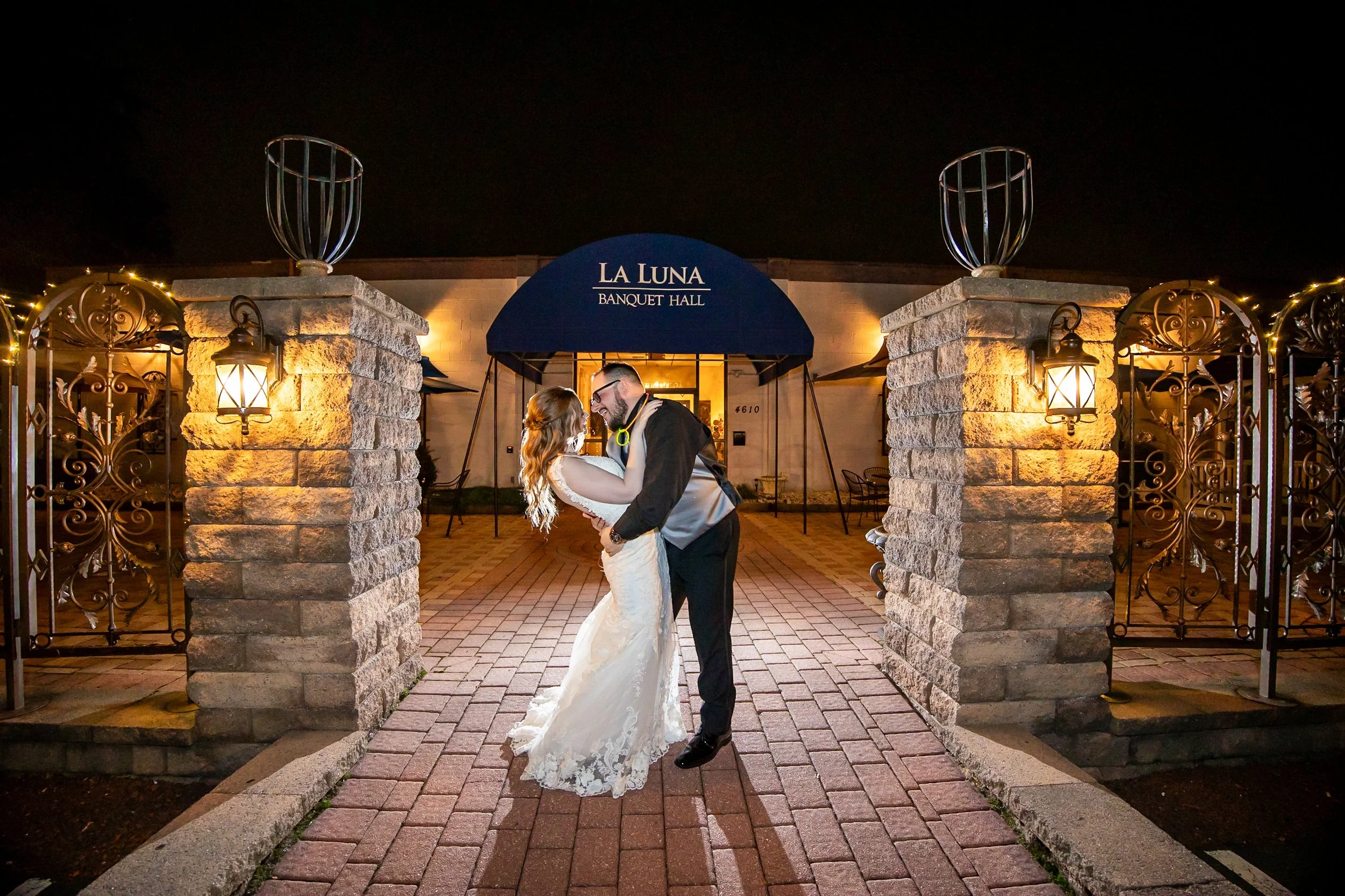 Bride and groom kissing on patio