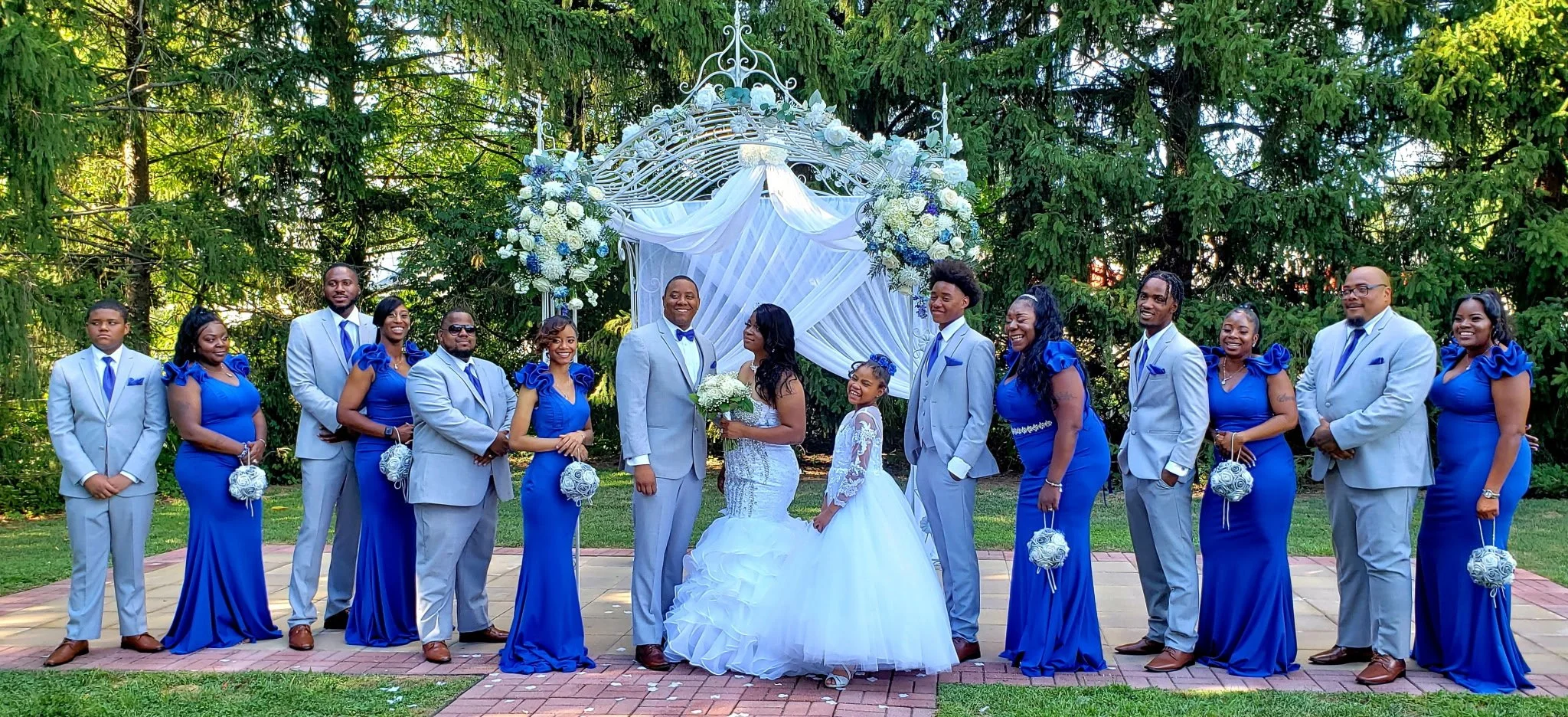 Bridal party under garden arch
