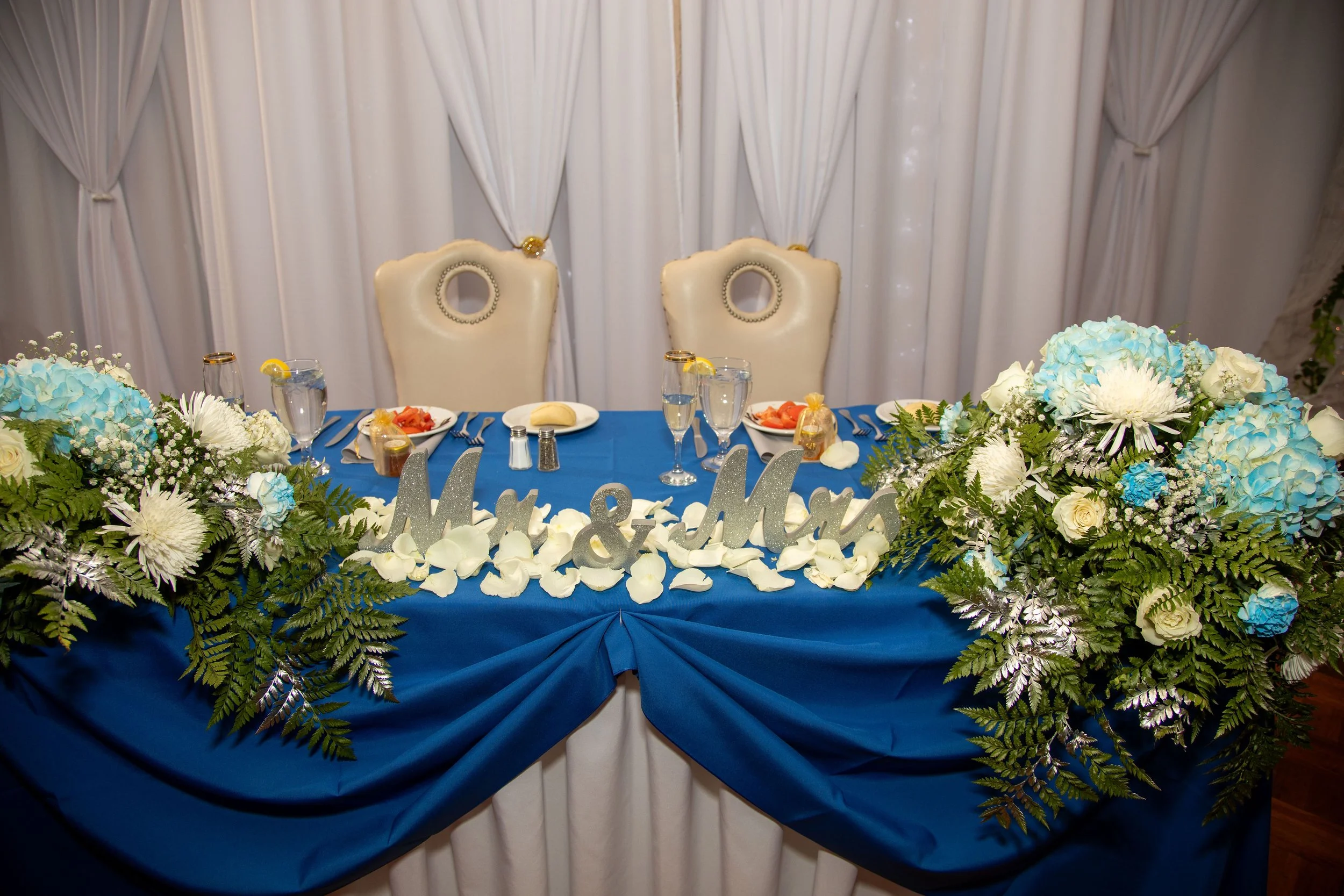 Blue linen head table with flowers