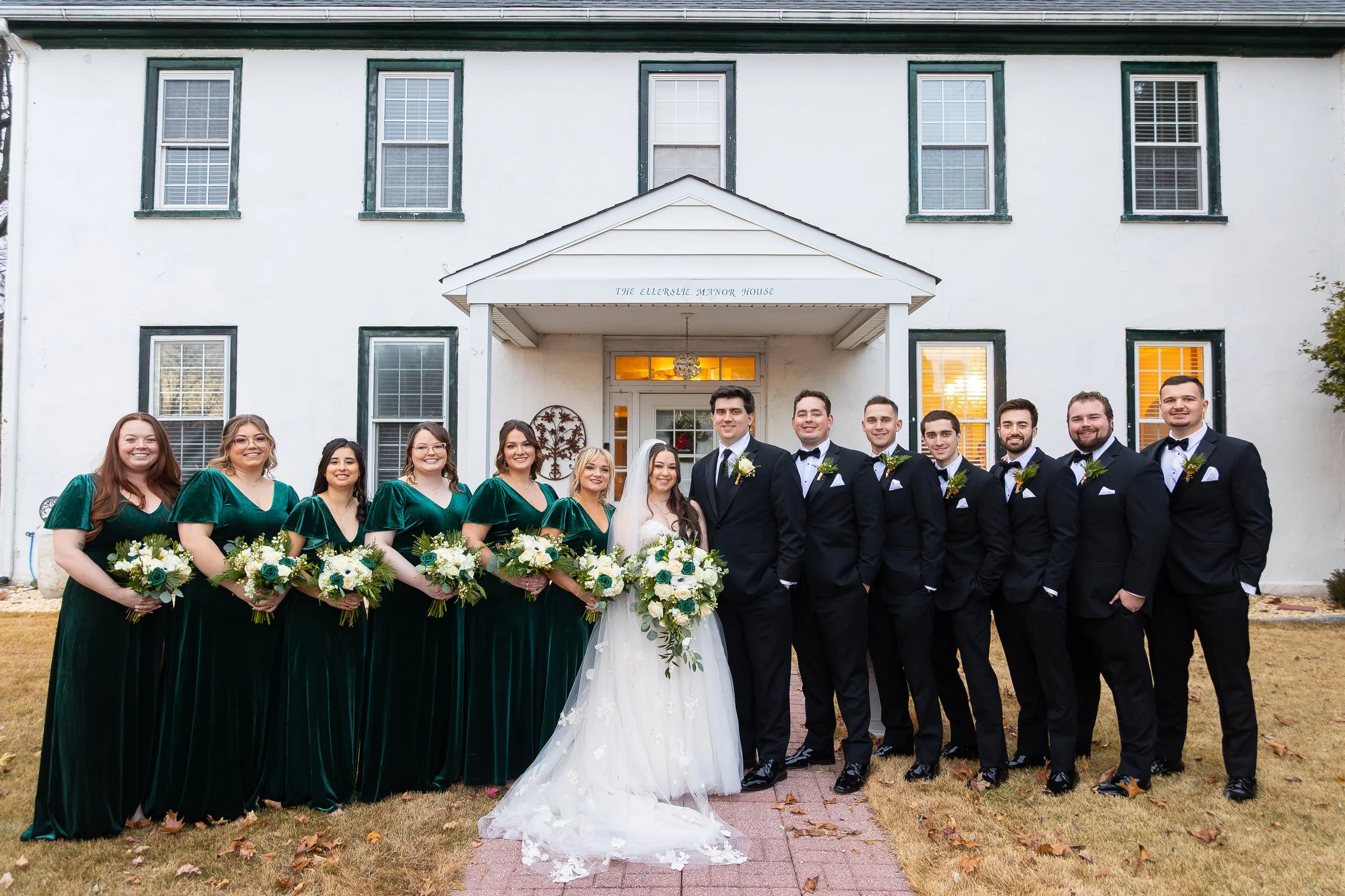 Bridal party outside manor house