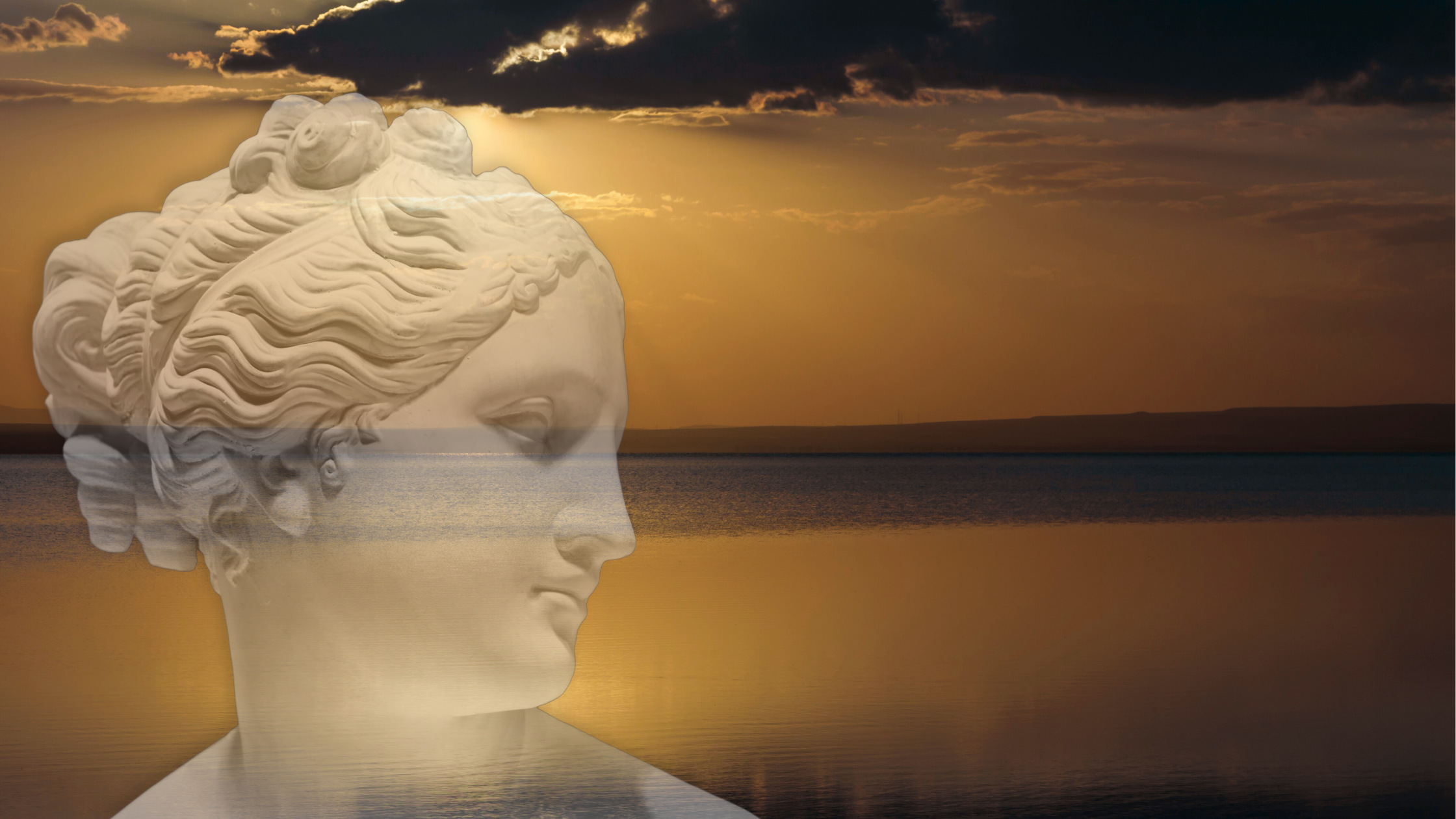 A sculpture of a human head in profile view with flowing hair, superimposed over a sunset landscape with water and cloudy sky.