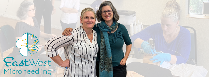 Two women smiling and posing together in a professional setting with a microscope, while other people work in the background, with a logo for East West Microneedling LLC in the bottom left corner.
