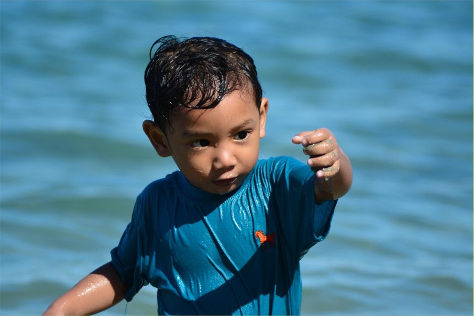 A young boy explores sensory play with water.