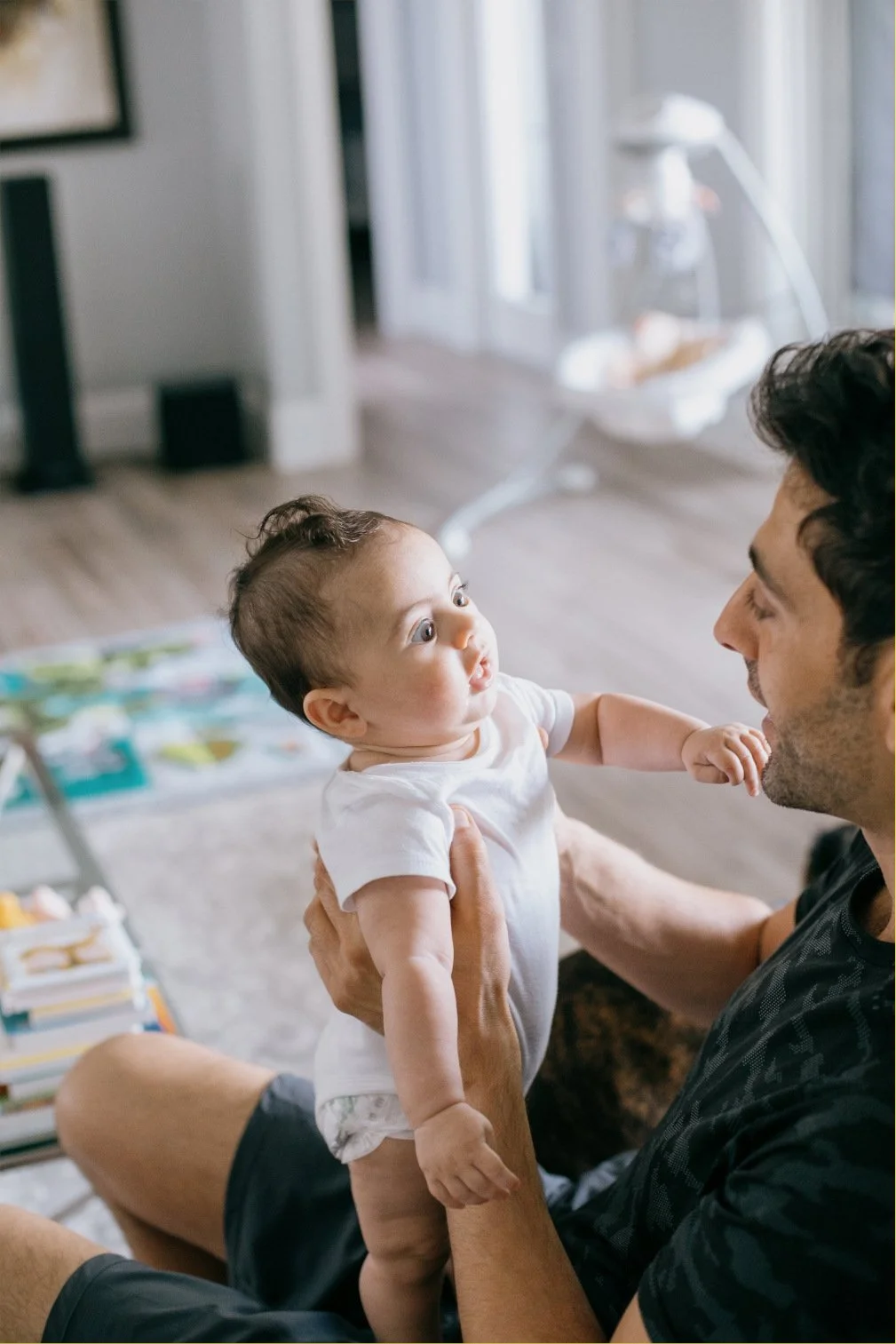 A baby gives a curious and funny look at their caregiver.
