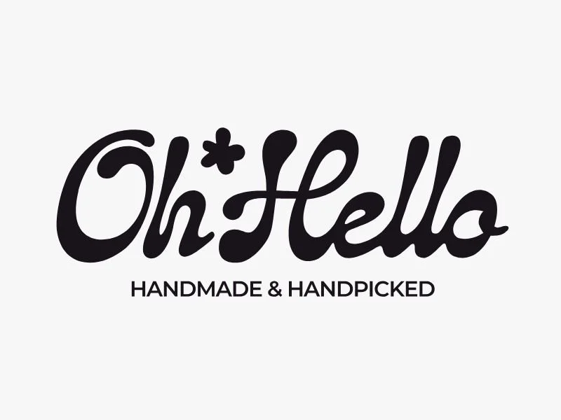 Logo that says 'Oh Hello' in stylized black font with a small star replacing the dot in the 'i', and beneath it, the text 'Handmade & Handpicked' in uppercase black letters.