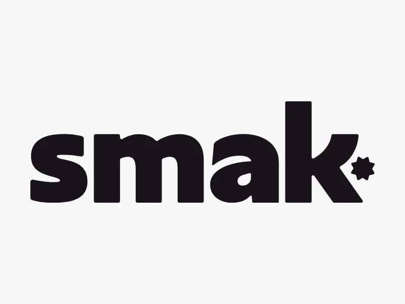 The word 'smak' in bold black lowercase letters with a small star shape at the end of the letter 'k' against a gray background.