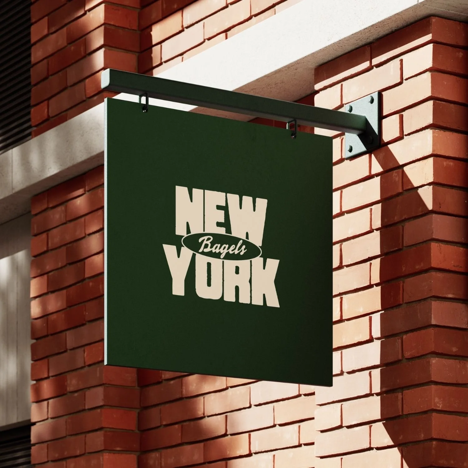 Sign for a store called 'New York Bagels' hanging on a brick wall.