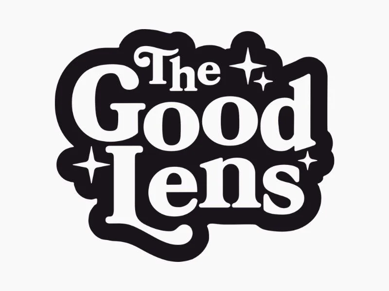 Black and white logo with the text 'The Good Lens' and three star icons.