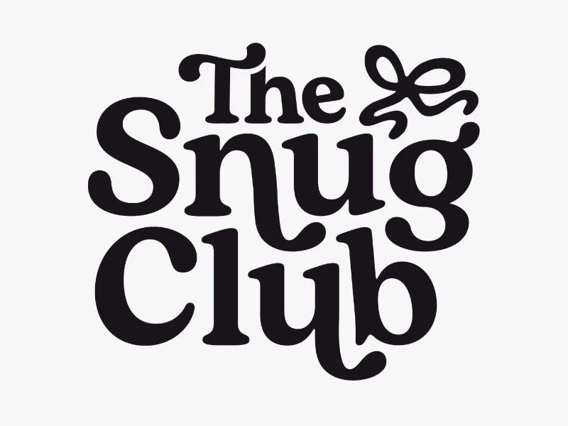 Logo for The Snug Club with stylized text and a small bow design.