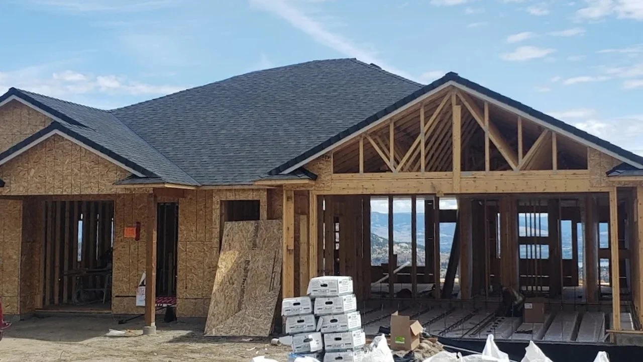 Partially completed roof showing underlayment and exposed plywood sheathing.