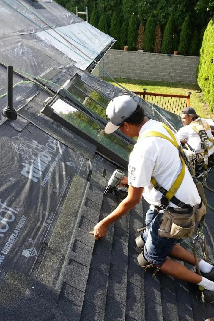 In-progress roofing repair showing open sections awaiting new shingles.