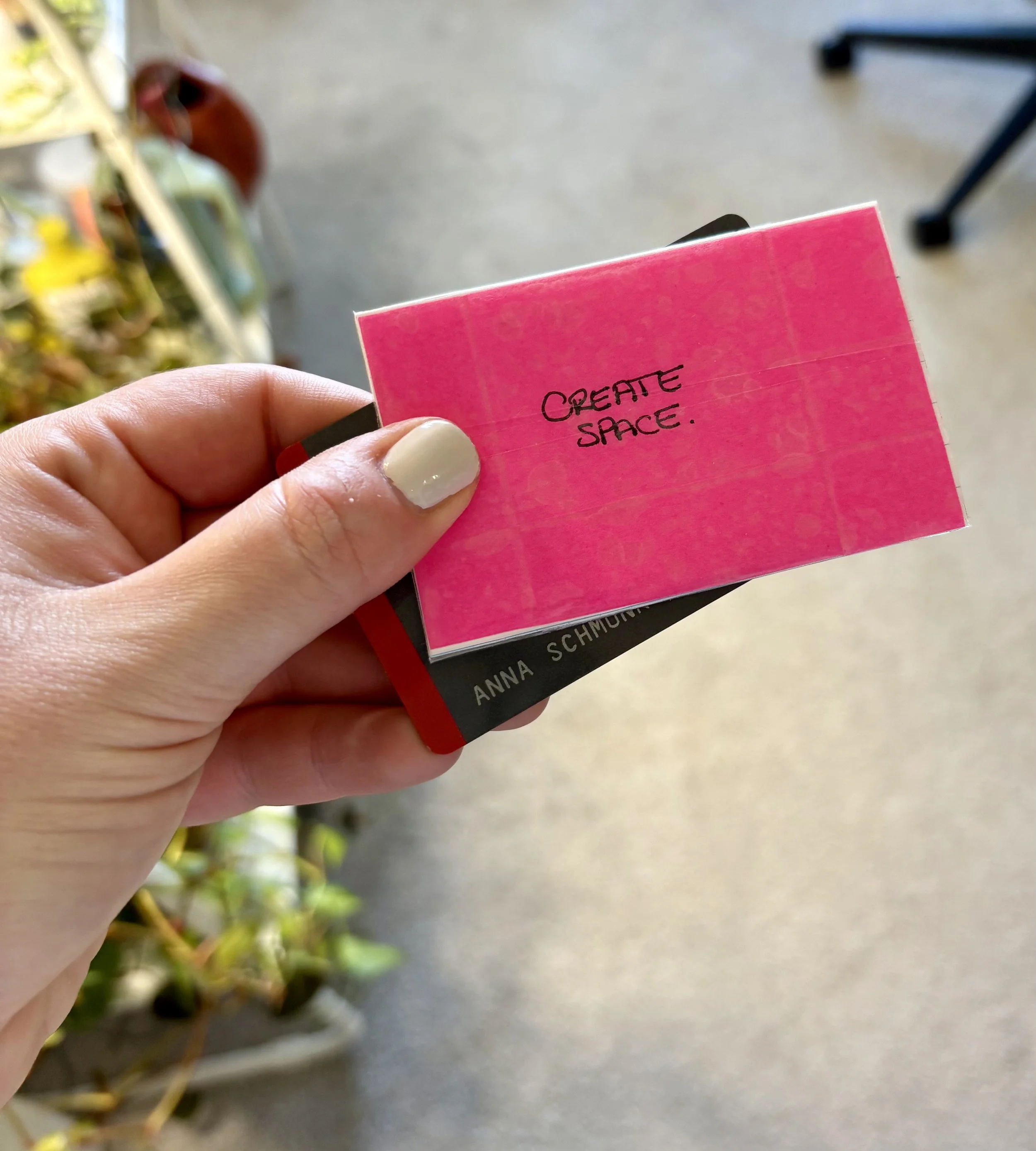 A small, hot pink card that says "create space" in handwritten font